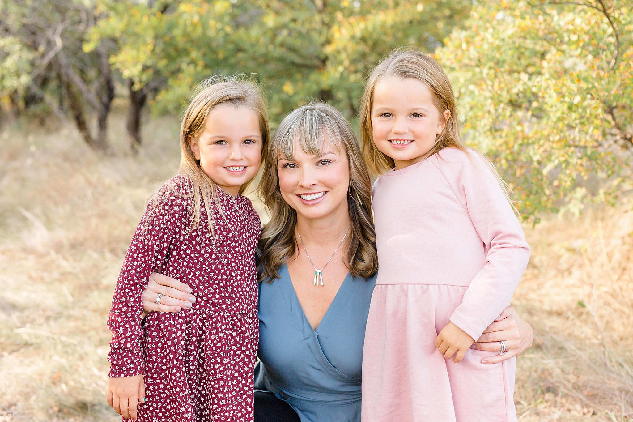 mom hugs two daughter during TX family photos