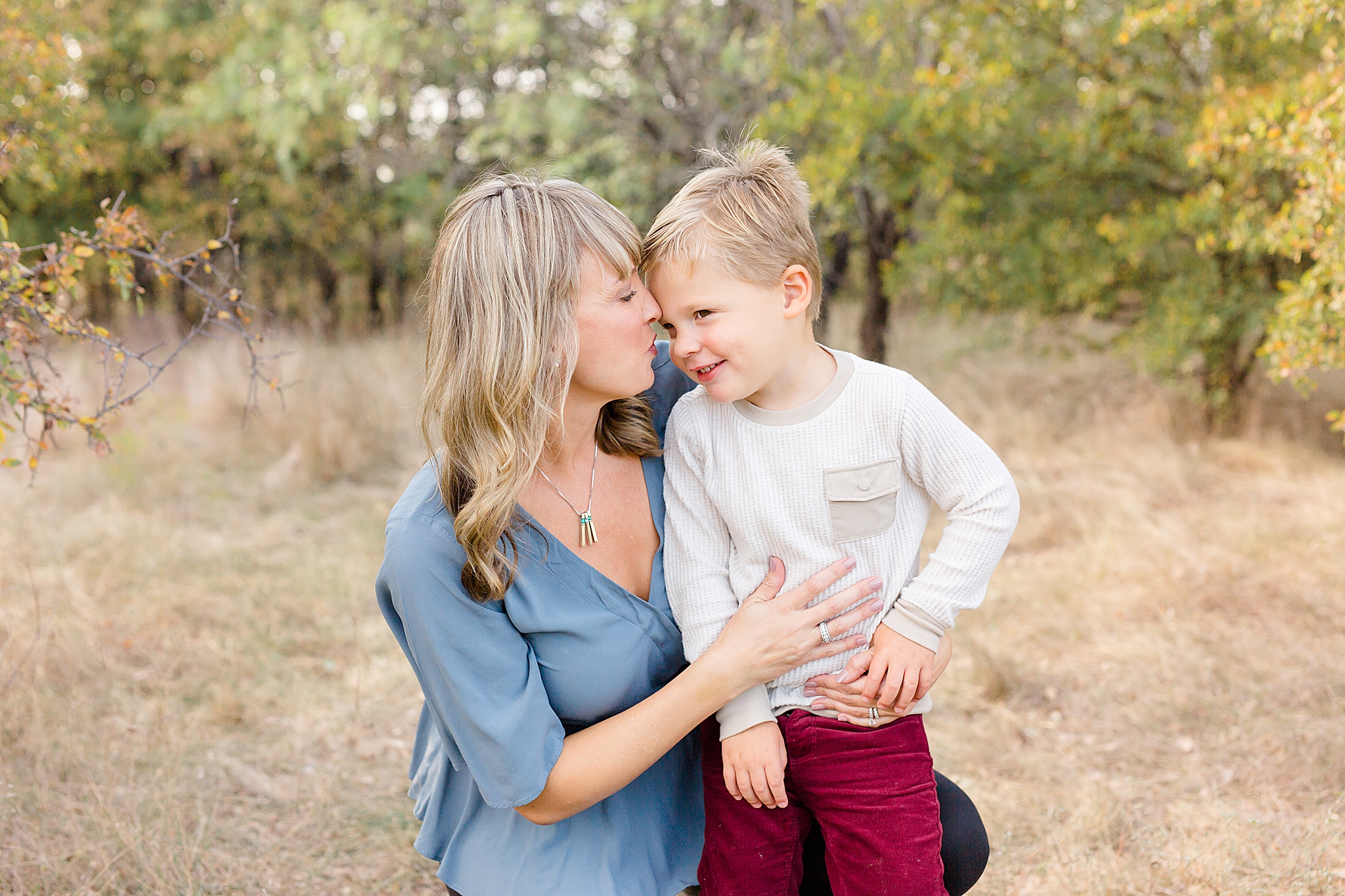 mom kisses son during family photos in Flower Mound TX