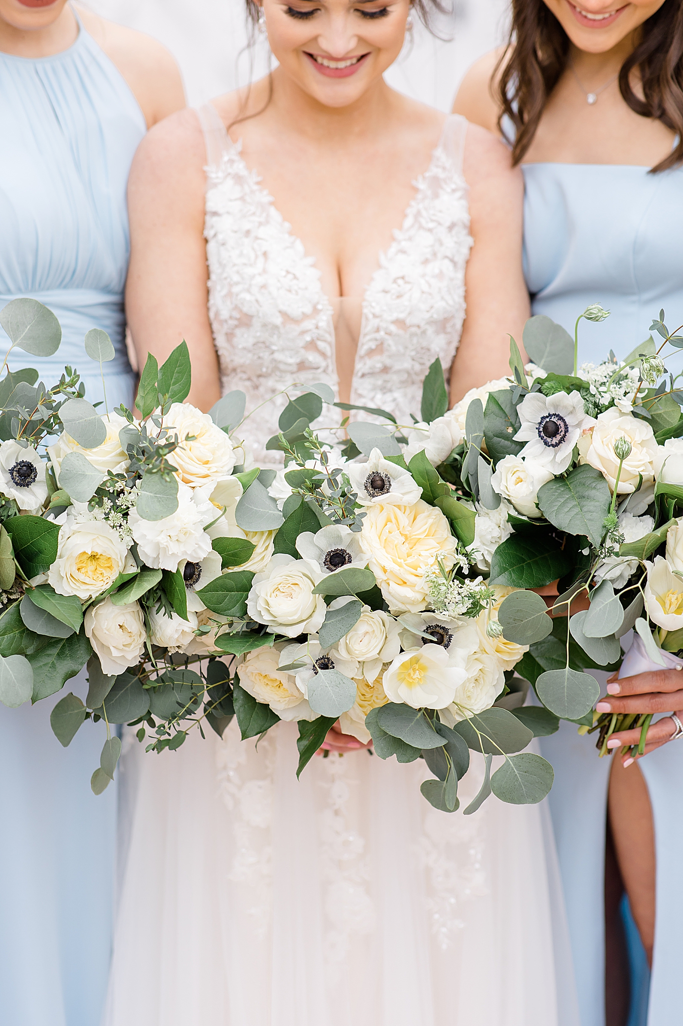 bride holds bouquet of white flowers outside The White Sparrow
