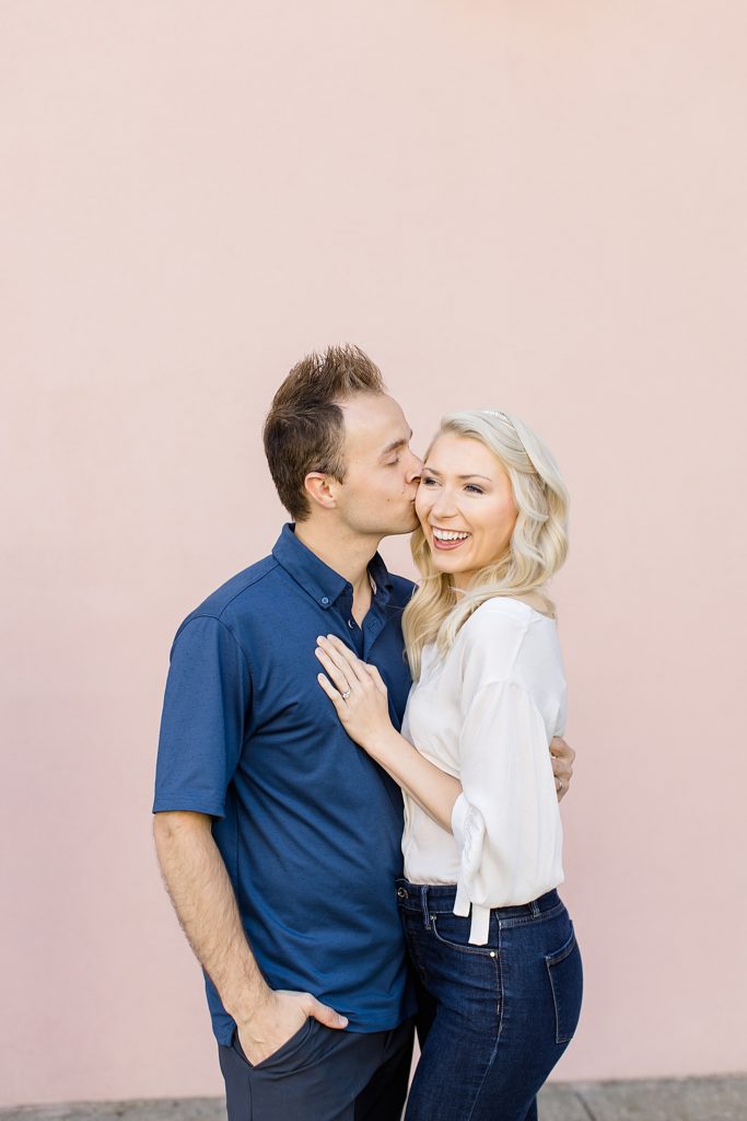 husband kisses wife's cheek during Charleston anniversary portraits