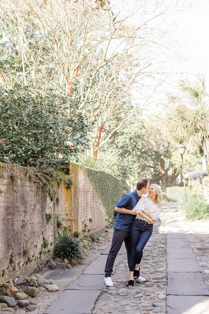couple kisses in alleyway of Charleston SC