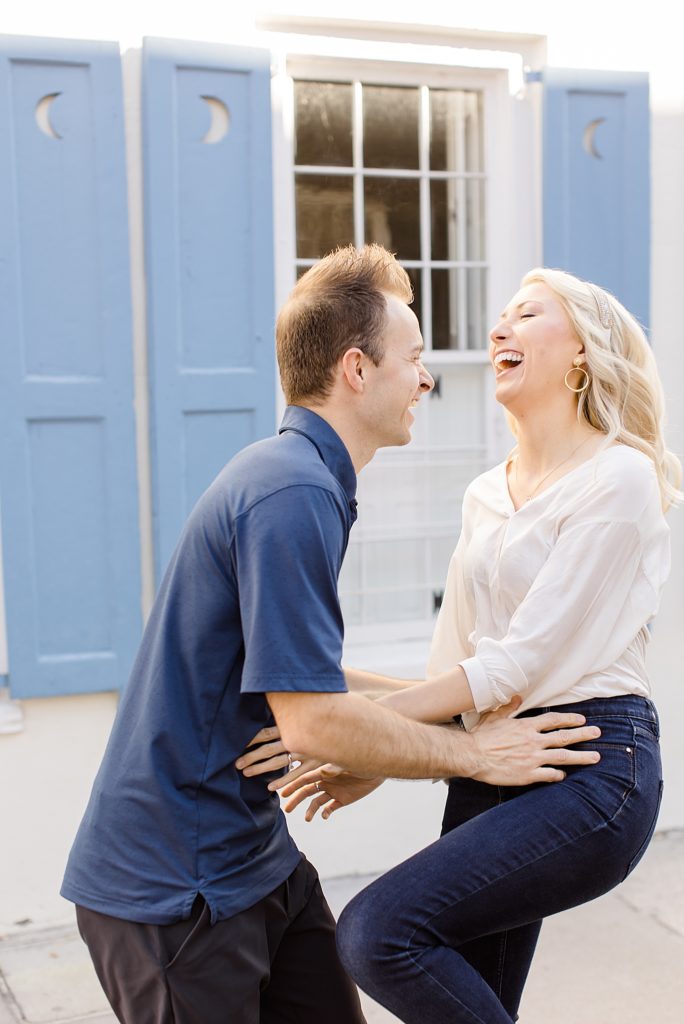 Charleston anniversary portraits with couple laughing by historic home