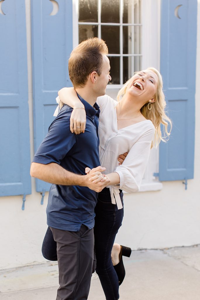 wife laughs with husband during Charleston anniversary portraits
