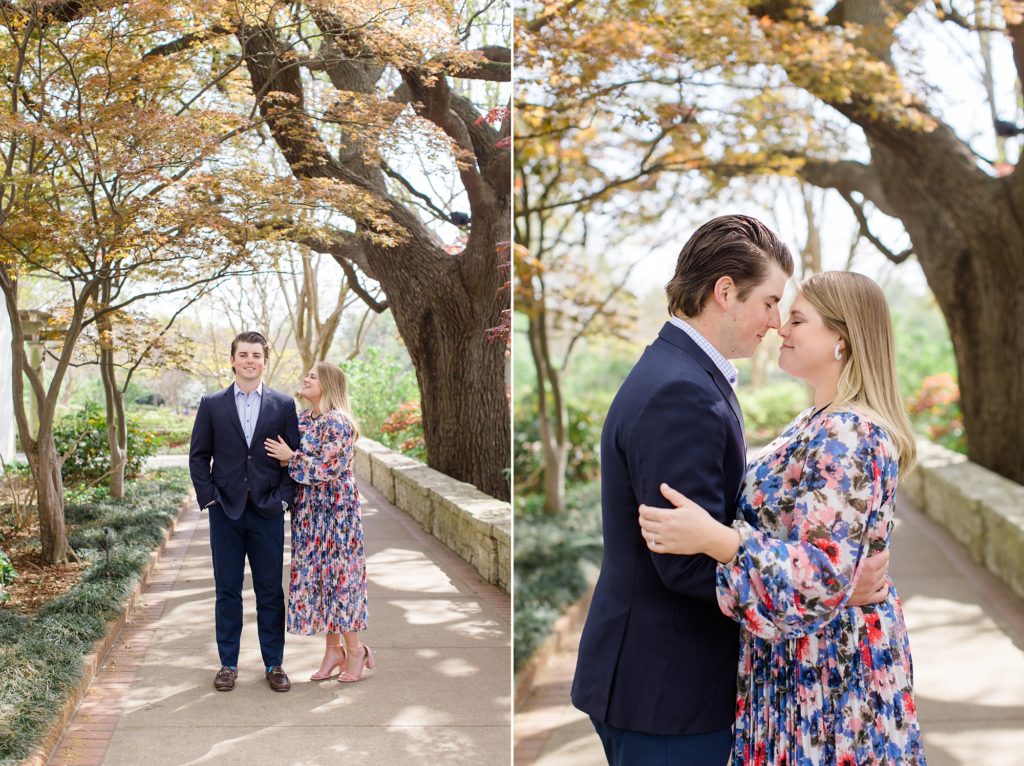 couple poses together under tree in Dallas Arboretum