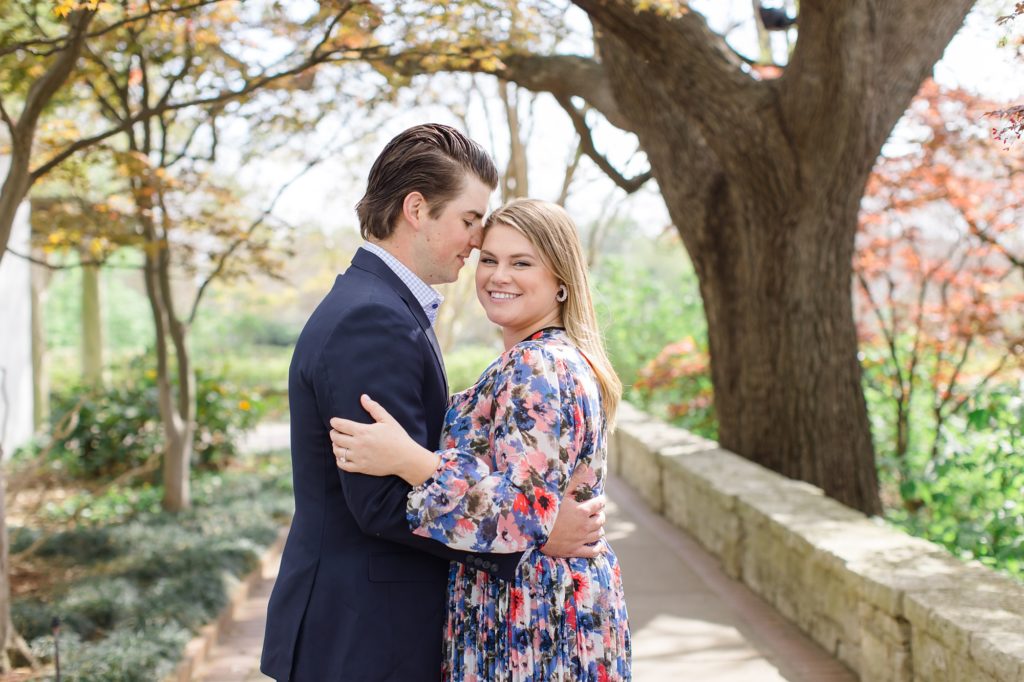 groom nuzzles bride's forehead during Dallas Arboretum engagement session