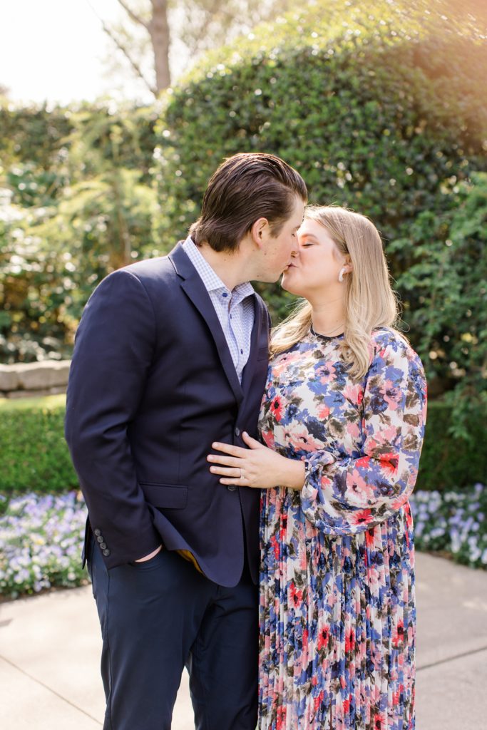 engaged copule kisses in Dallas Arboretum