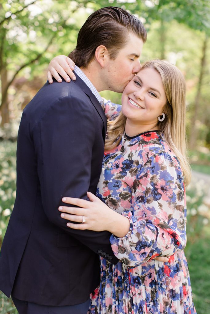 groom kisses bride's forehead during spring engagement session in Texas 