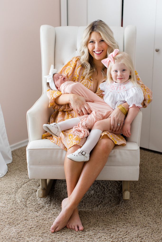 newborn photos at home for baby girl and big sister 