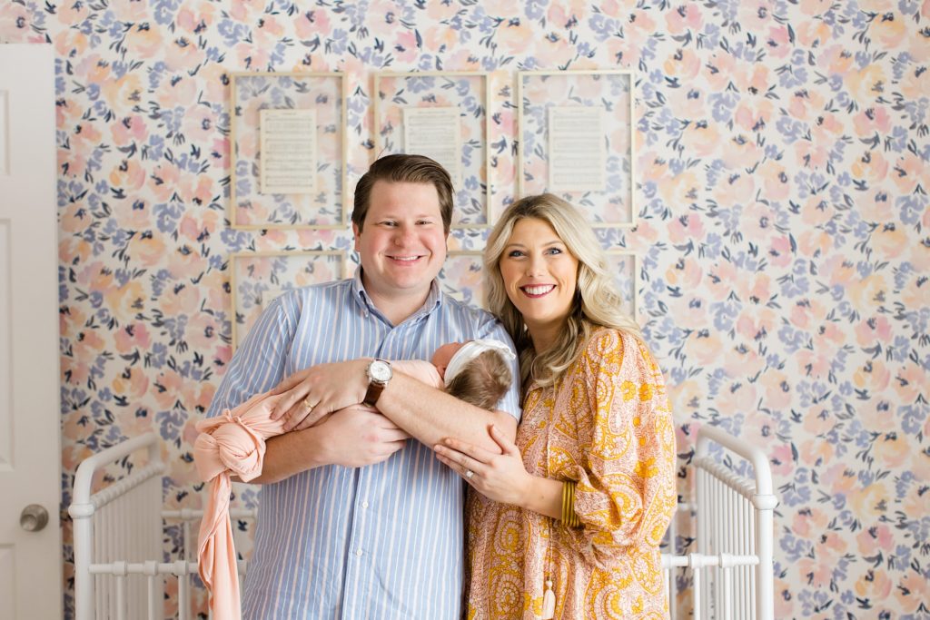 parents hold new baby girl during Dallas lifestyle newborn portraits