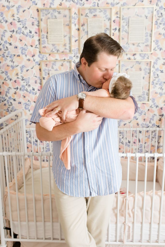 dad kisses new baby during Dallas lifestyle newborn portraits
