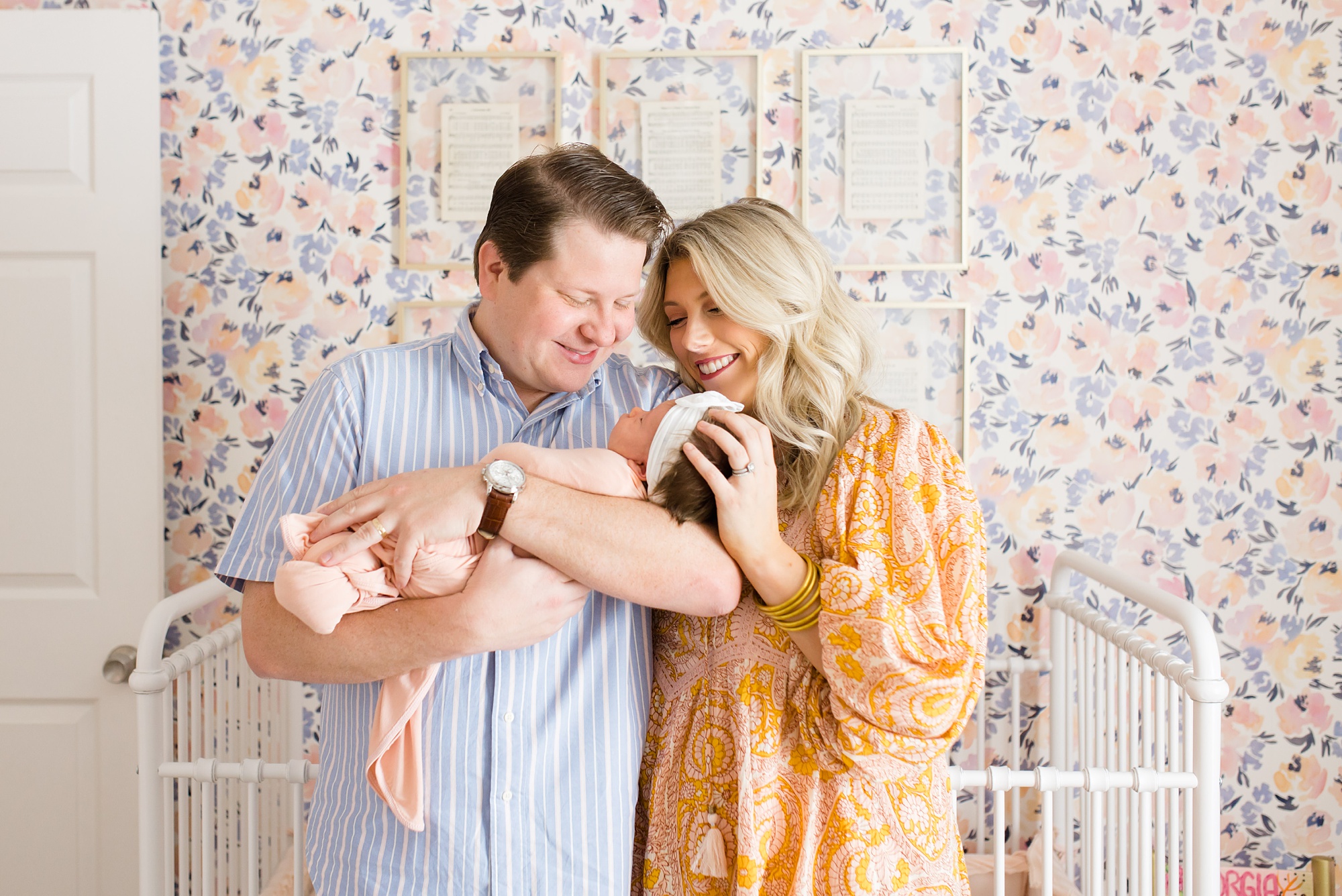 newborn portraits with mom and dad holding baby girl