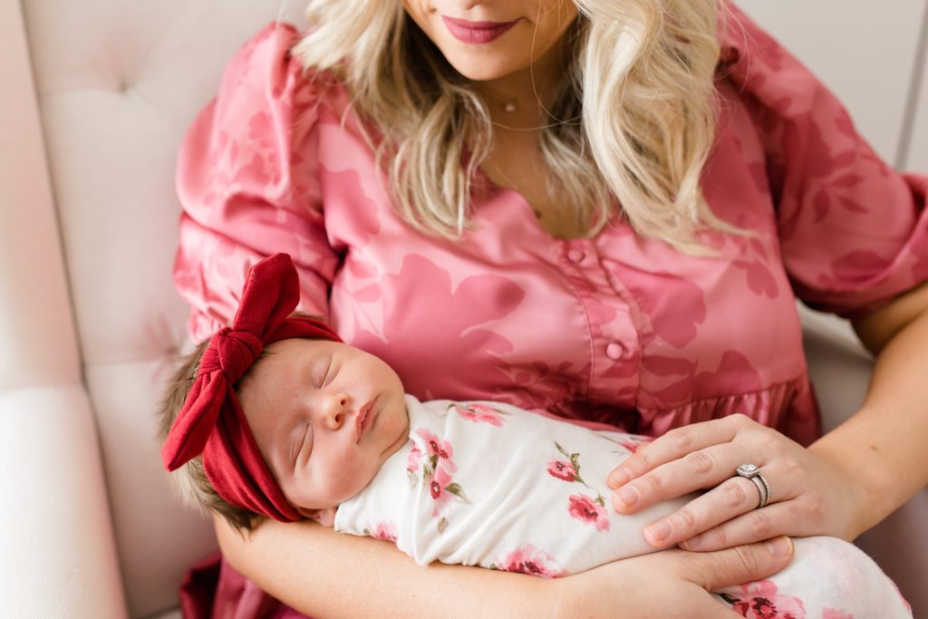 baby girl sleeps in mom's arms during Dallas lifestyle newborn portraits