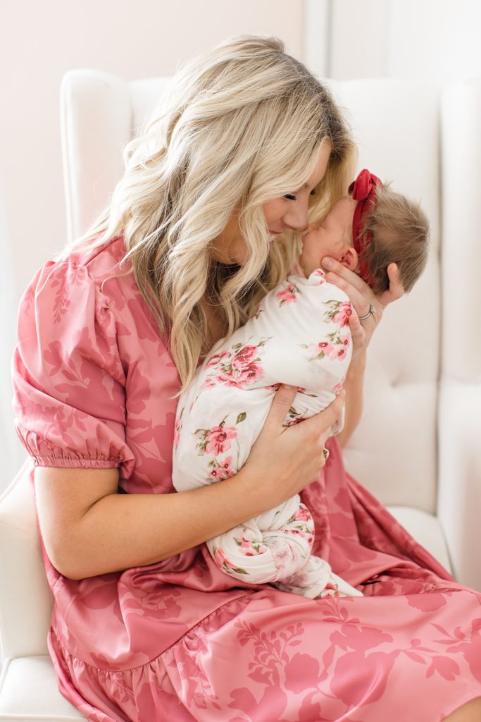 mom nuzzles baby girl during Dallas lifestyle newborn portraits
