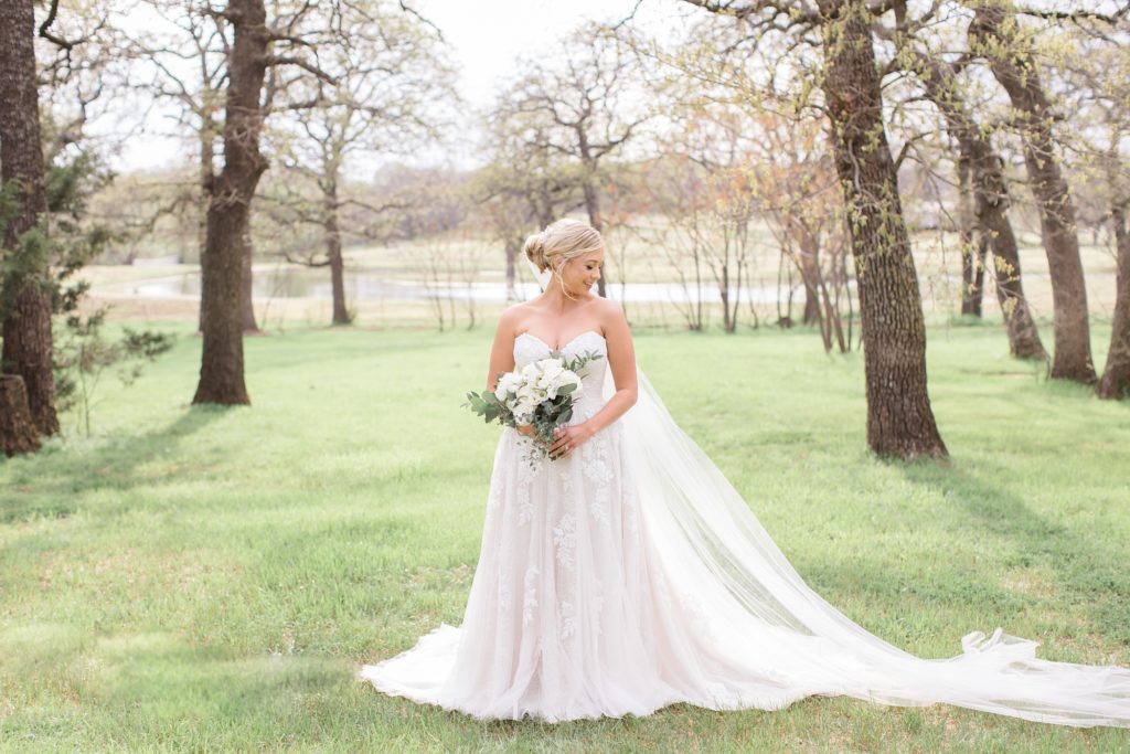 classic bridal session in Texas with bride standing in meadow