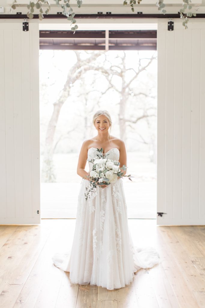 bride walks through doors at Oak + Ivy