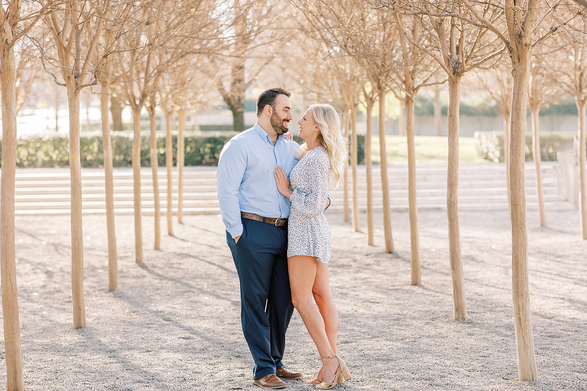 bride and groom smile at each other standing in trees at Kimball Art Museum