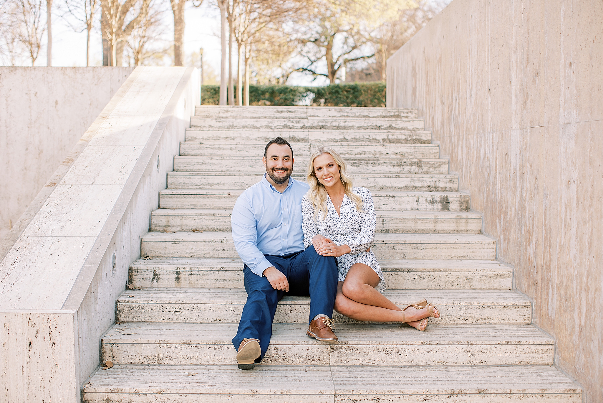 engaged couple sits on steps in Fort Worth TX