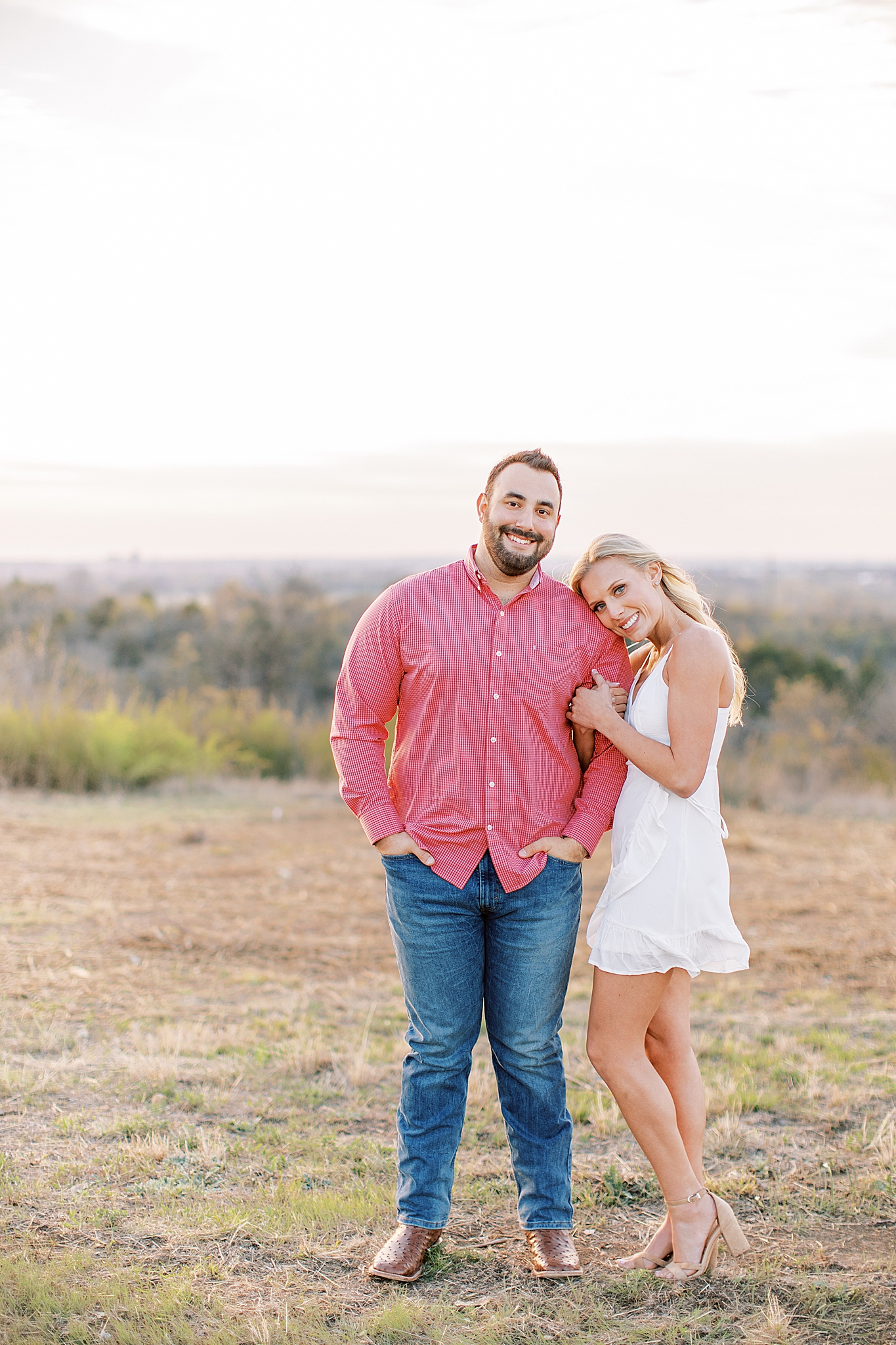 bride leans against groom during Texas engagement photos