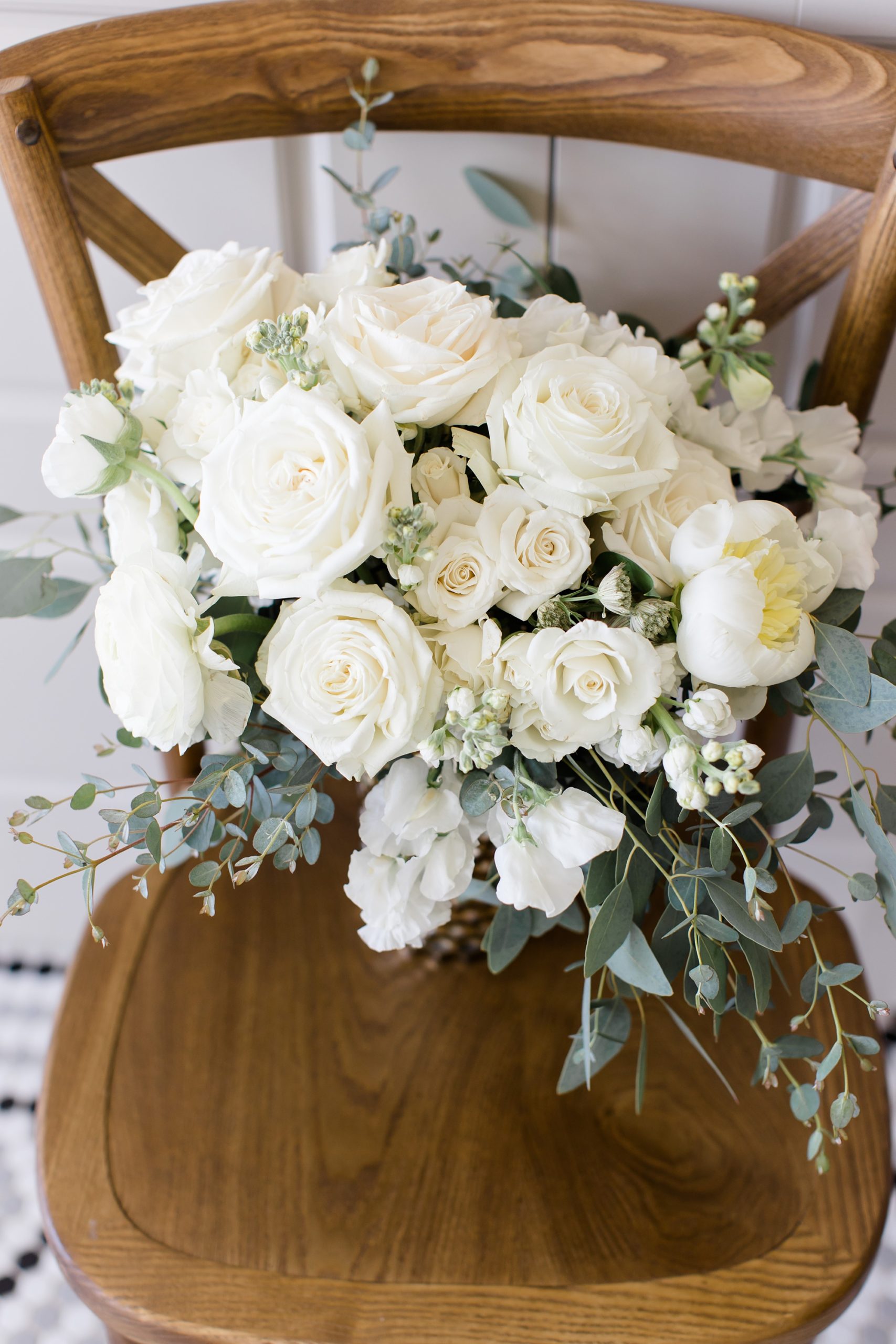 bride's bouquet sits on wooden chair