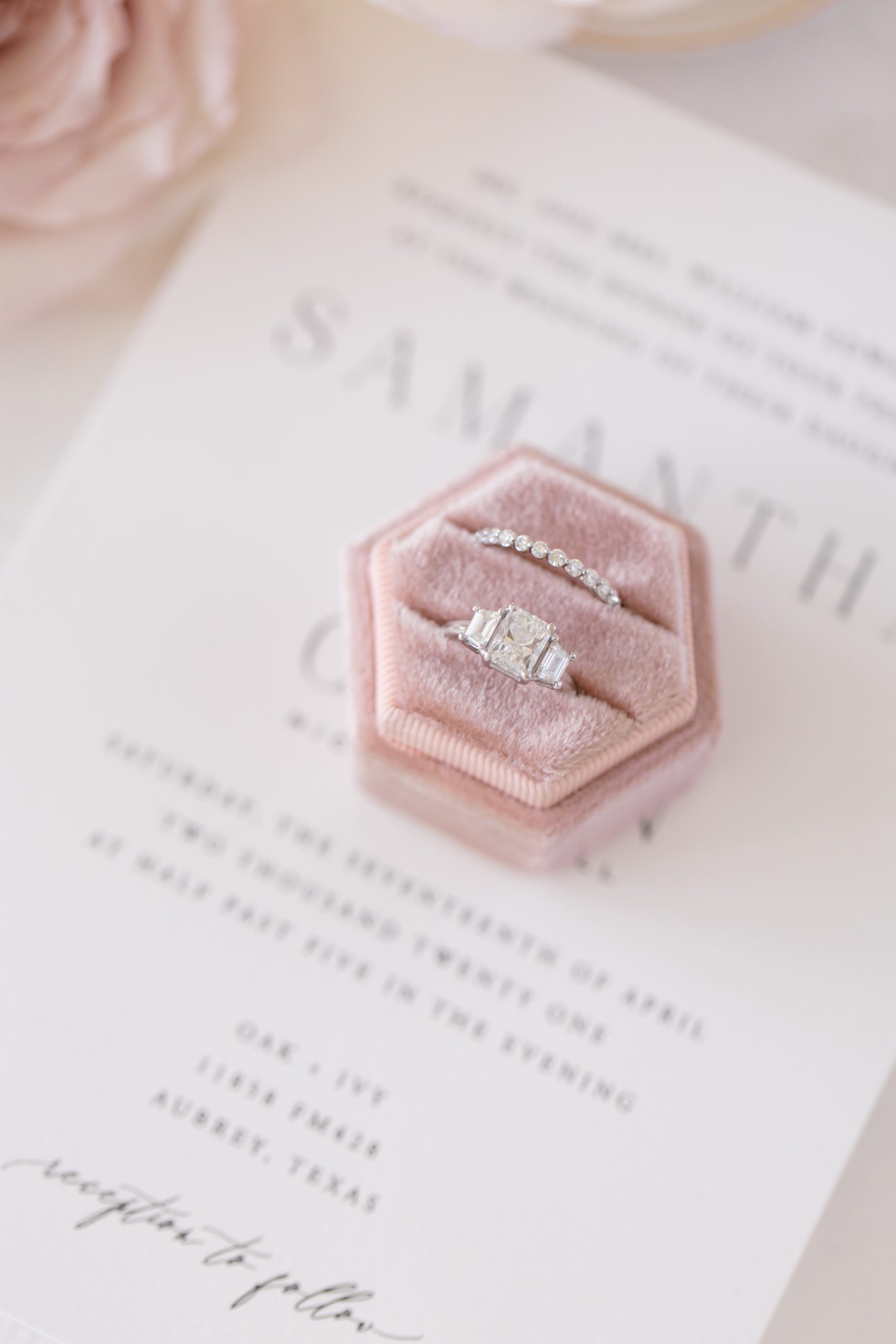 wedding ring rests in pastel pink ring box
