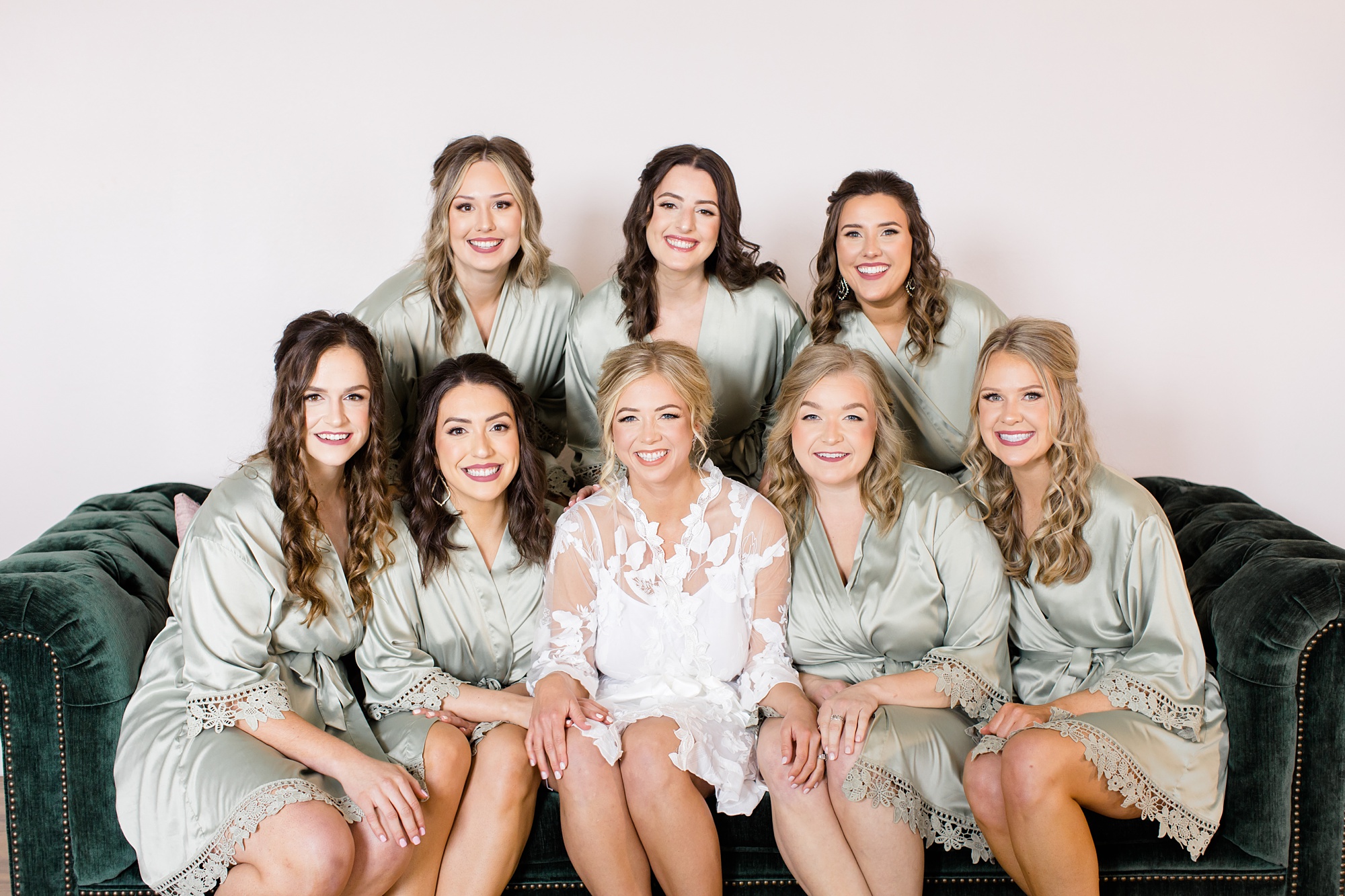 bride and bridesmaids pose in mint green robes