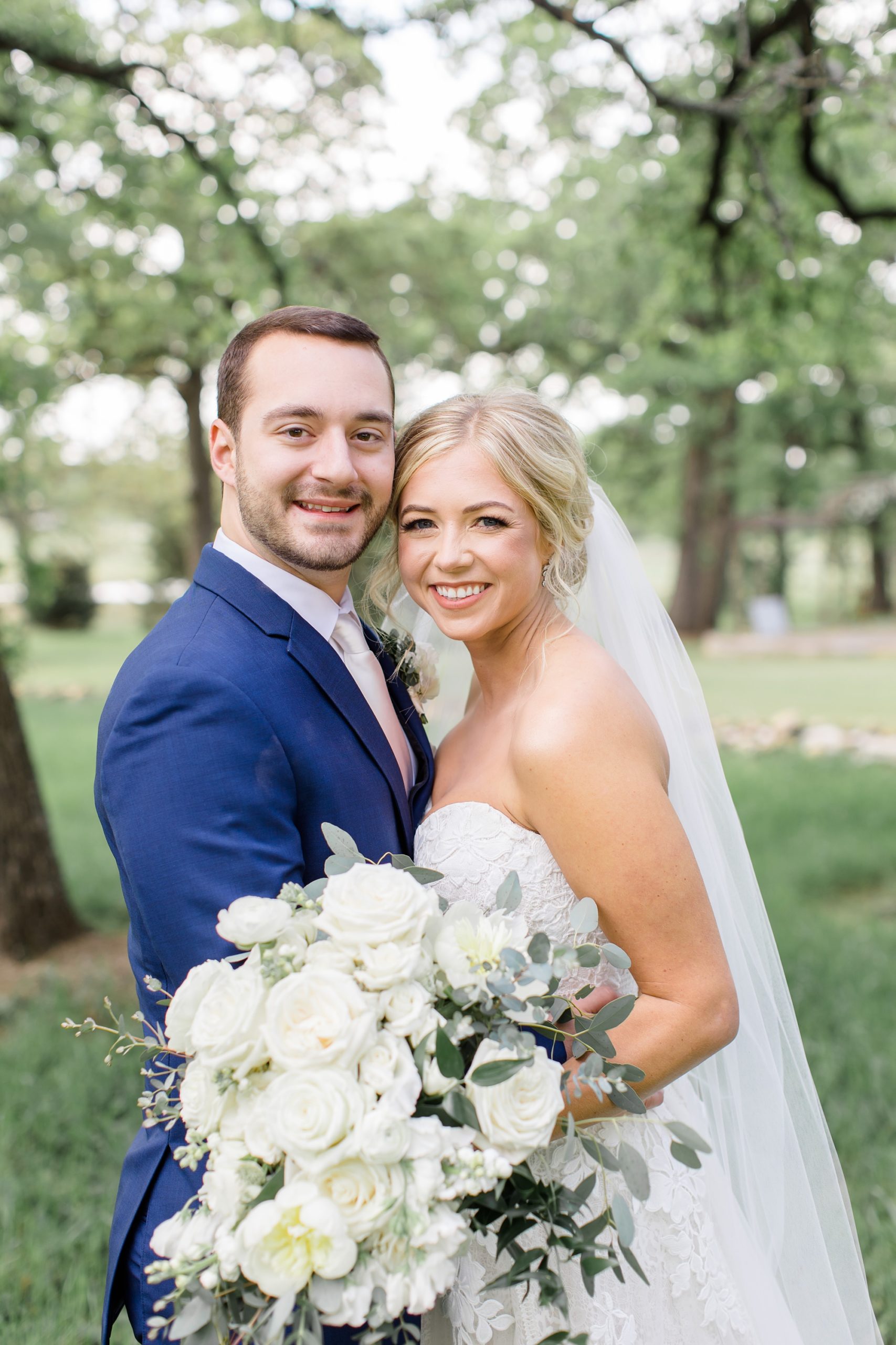 bride leans into groom during Texas wedding photos