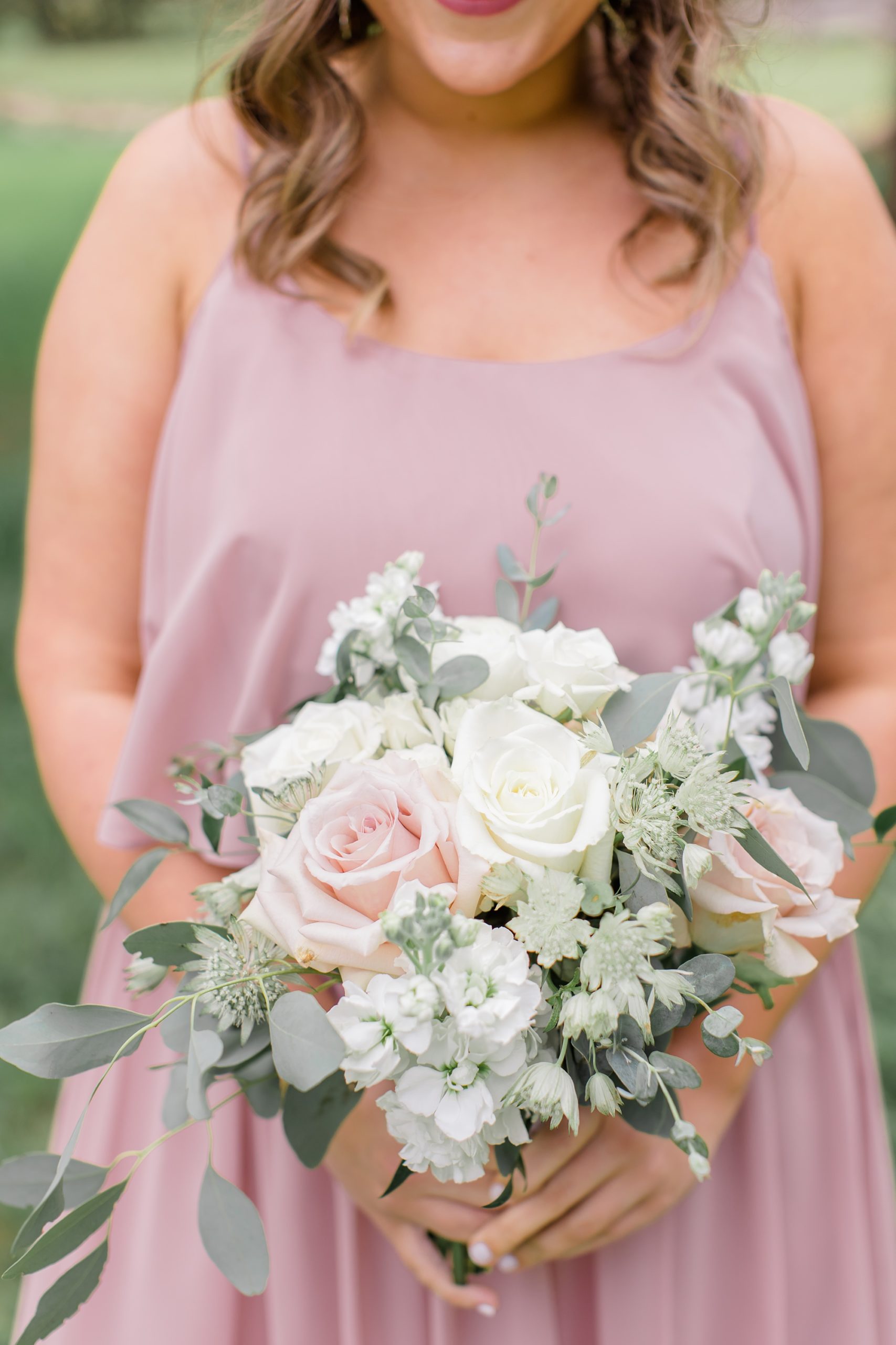 bridesmaid in dusty pink dress with bouquet of pink and white