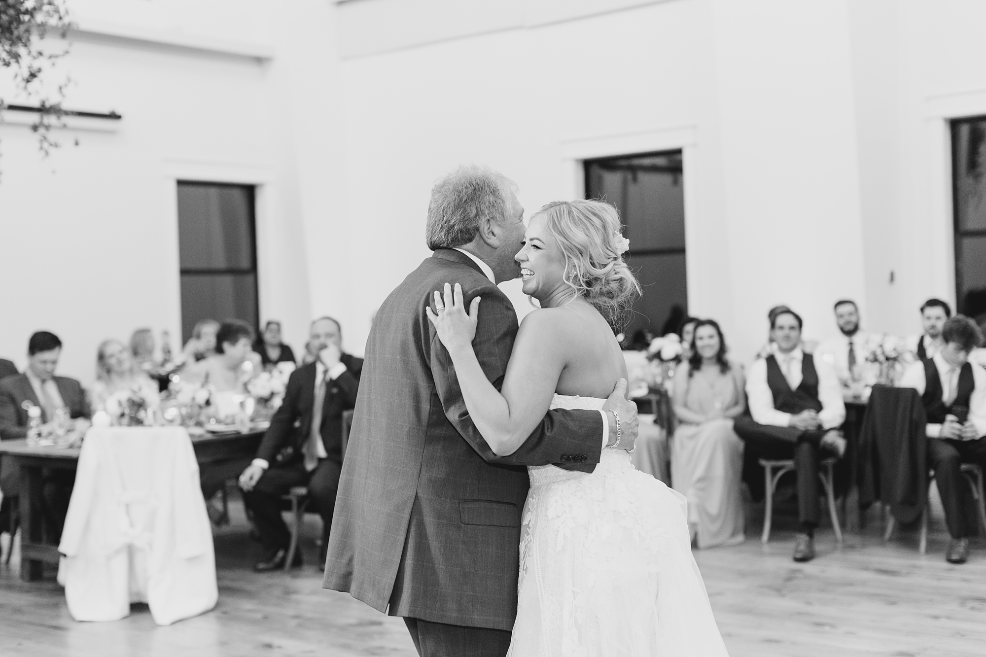 bride and dad dance on floor at Oak + Ivy