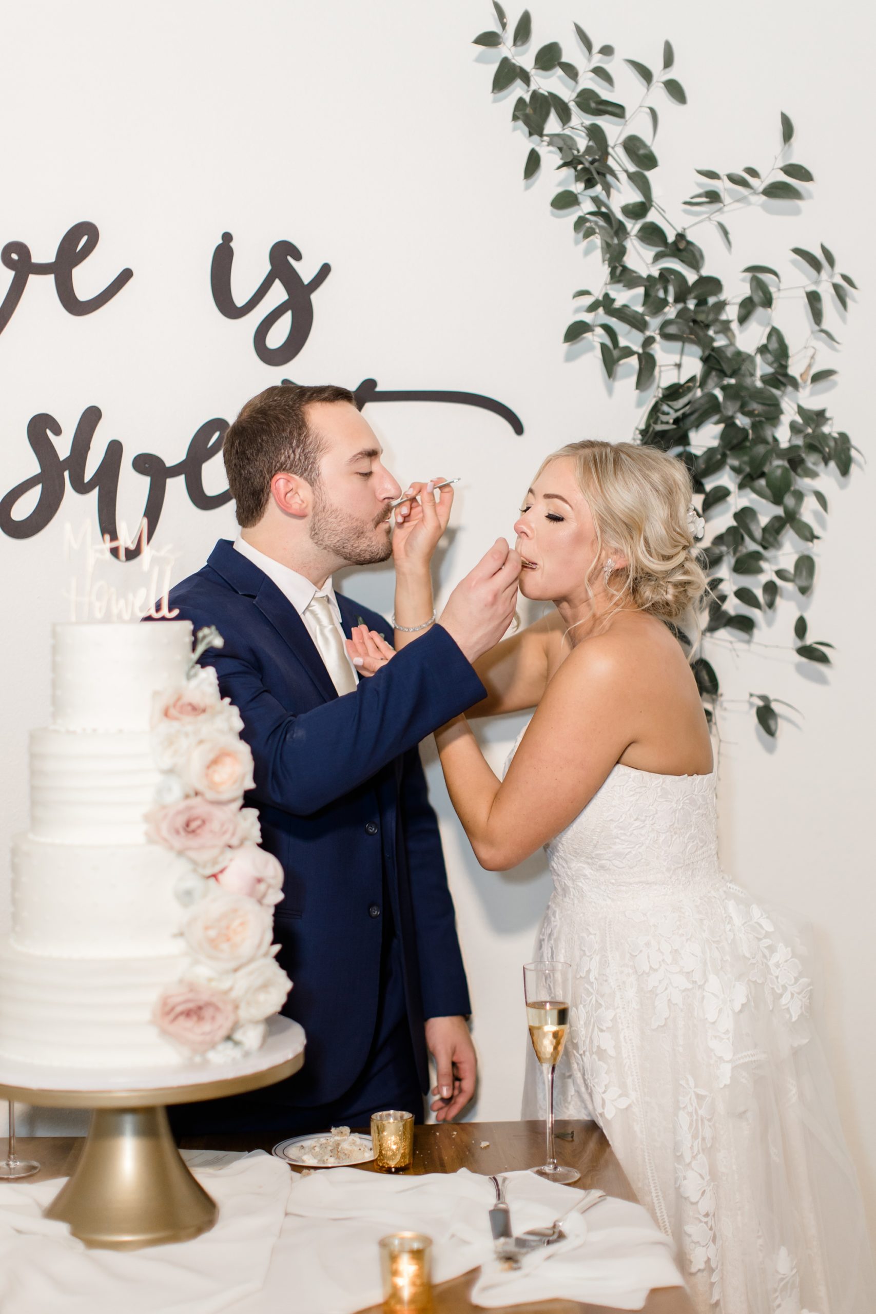 bride and groom eat cake during reception