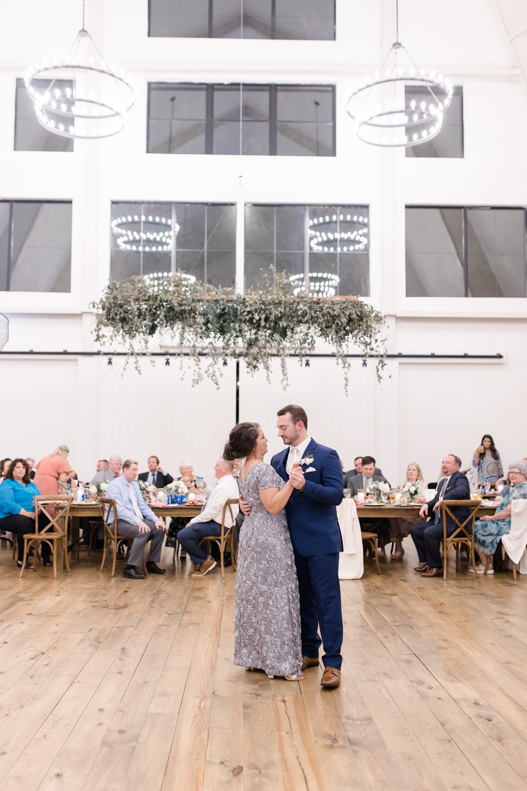 groom and mom dance during Oak + Ivy wedding reception