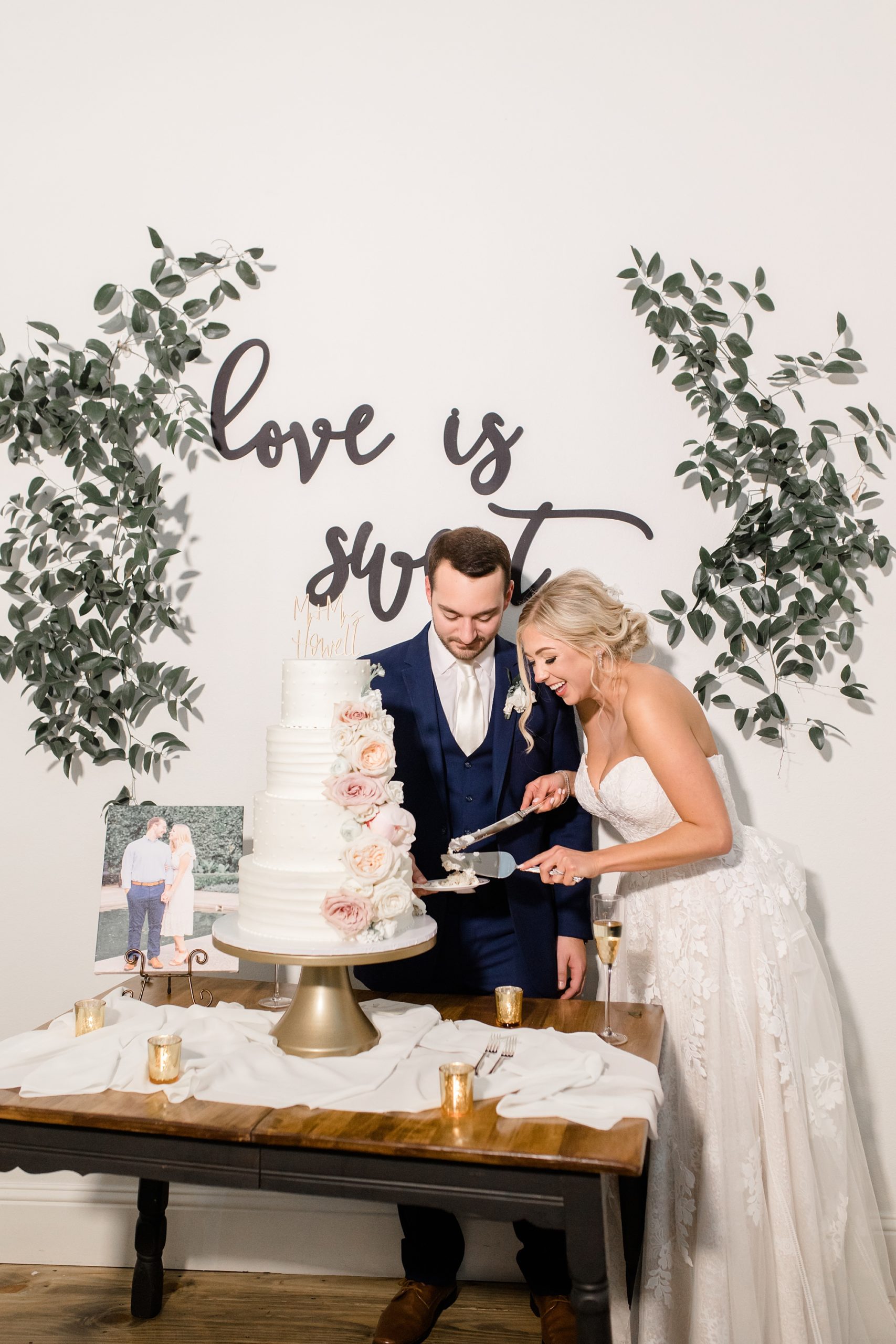 bride and groom cut wedding cake during Aubrey TX reception