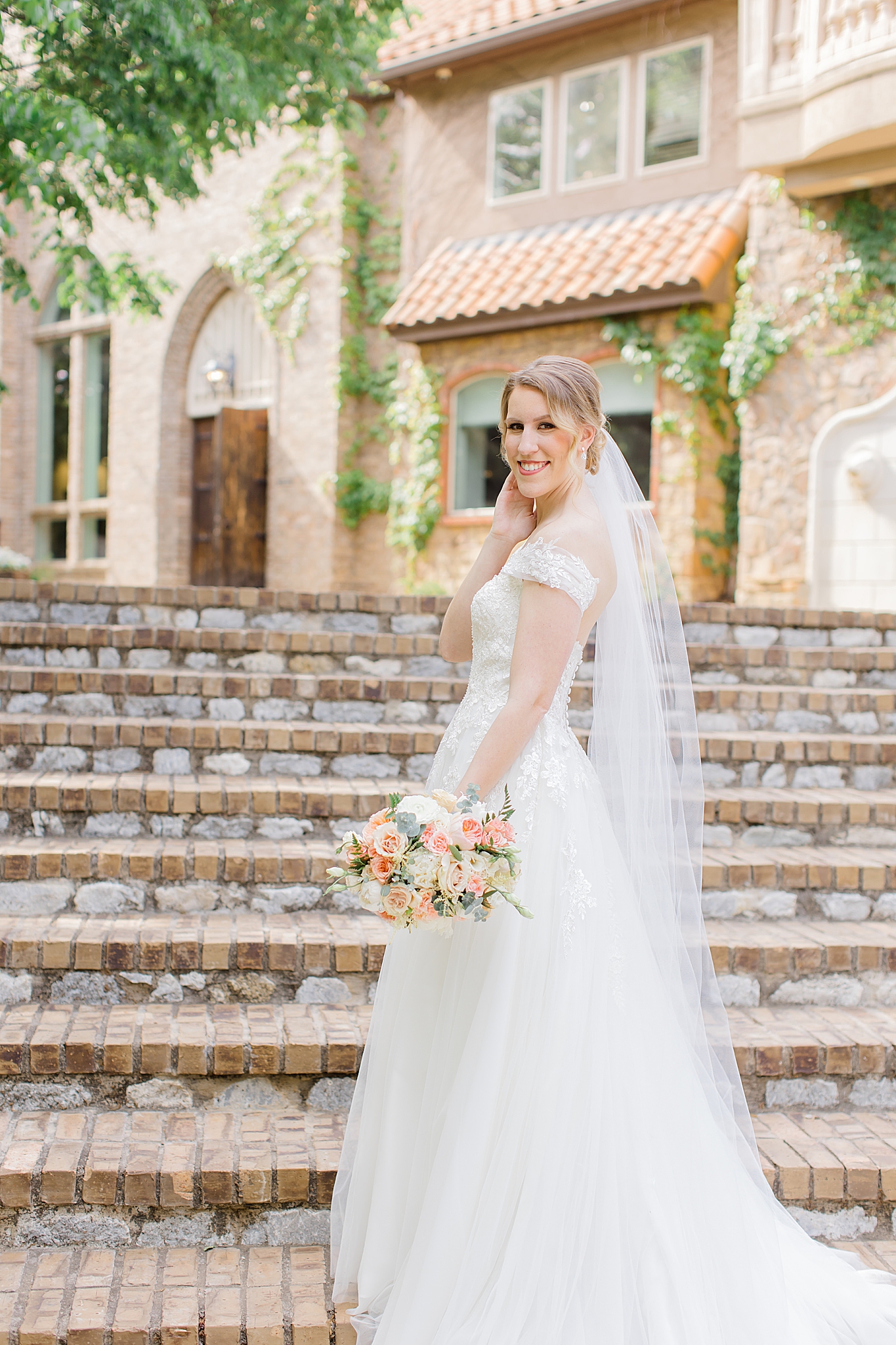 bride looks over shoulders during bridal portraits 