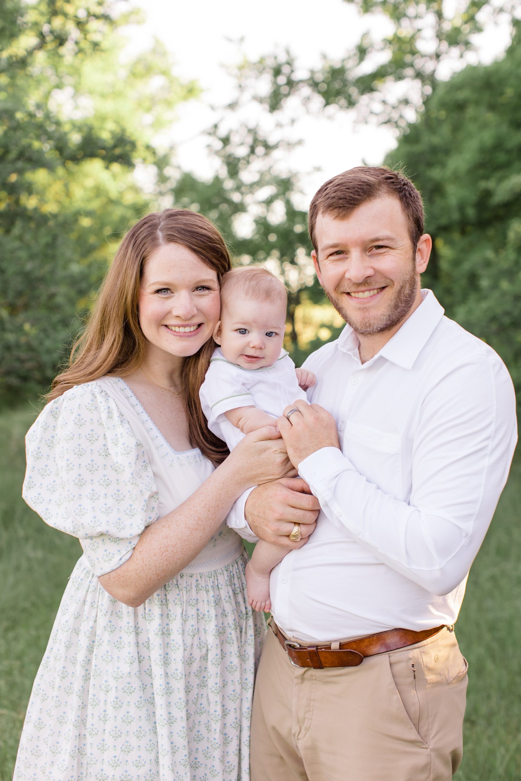 parents hold baby boy during spring portraits in Murrell Park