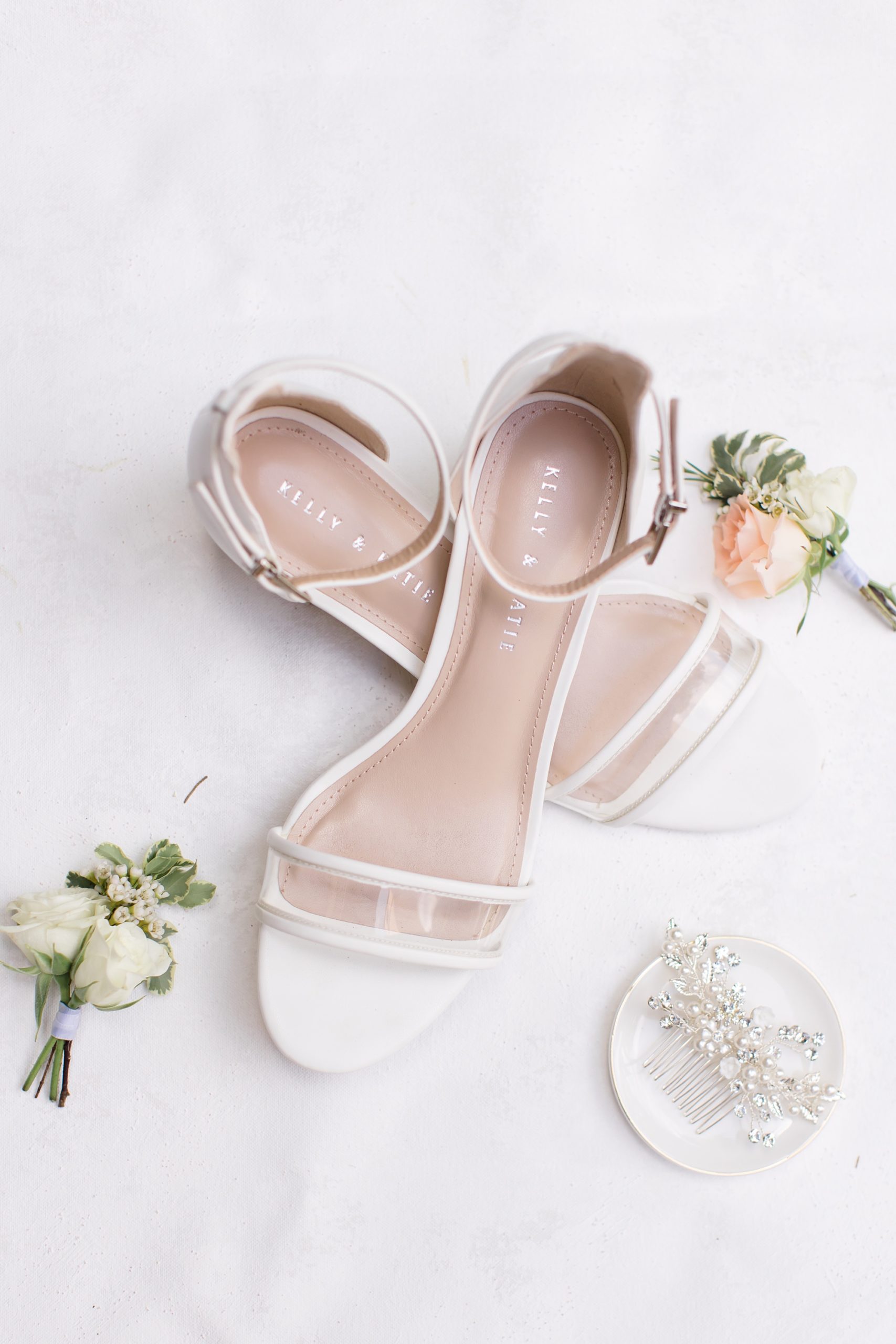bride's shoes rest on ivory flatlay 