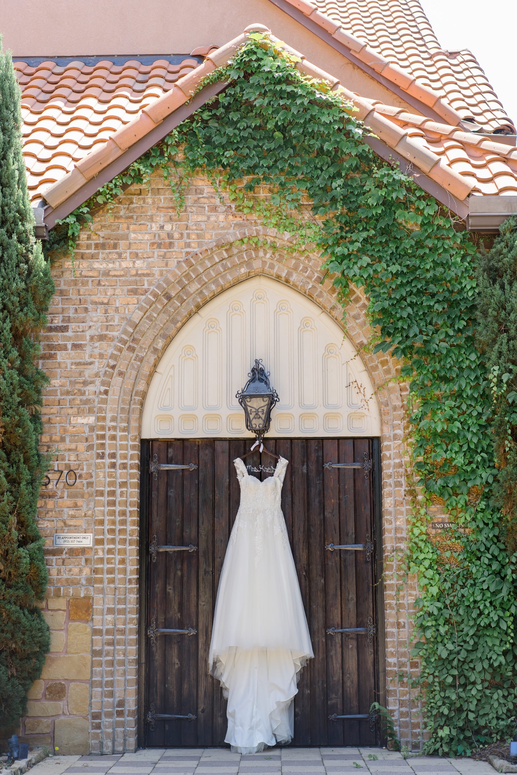 wedding dress hangs outside Aristide Mansfield