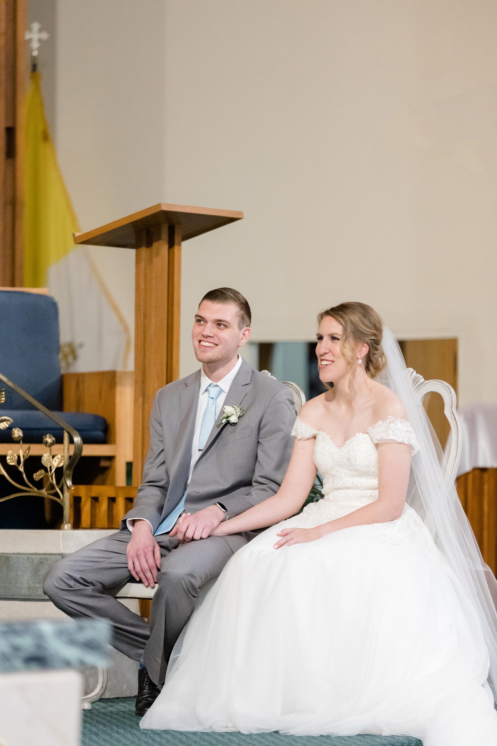 bride and groom sit together during traditional church wedding in Texas