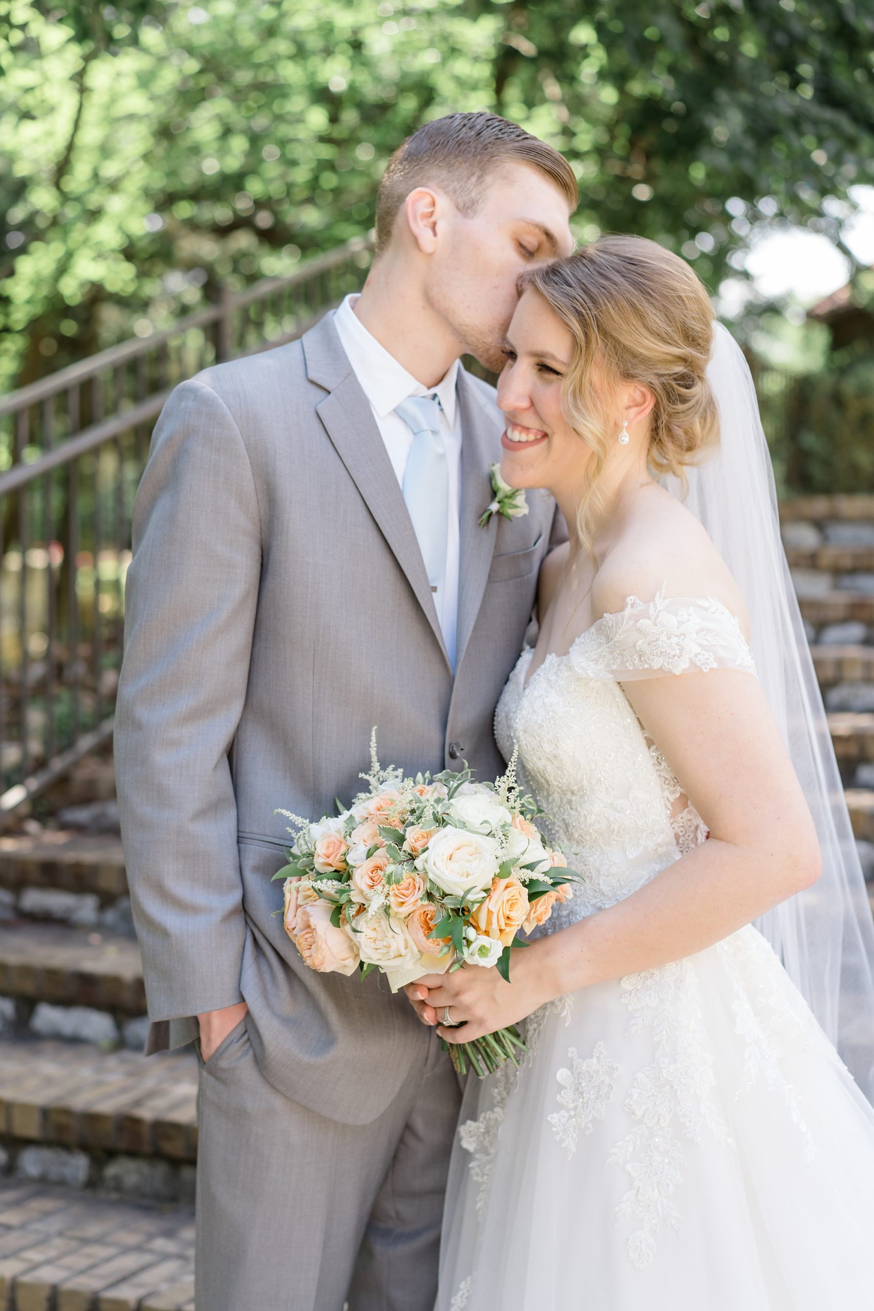 groom whispers in bride's ear during Texas wedding photos 