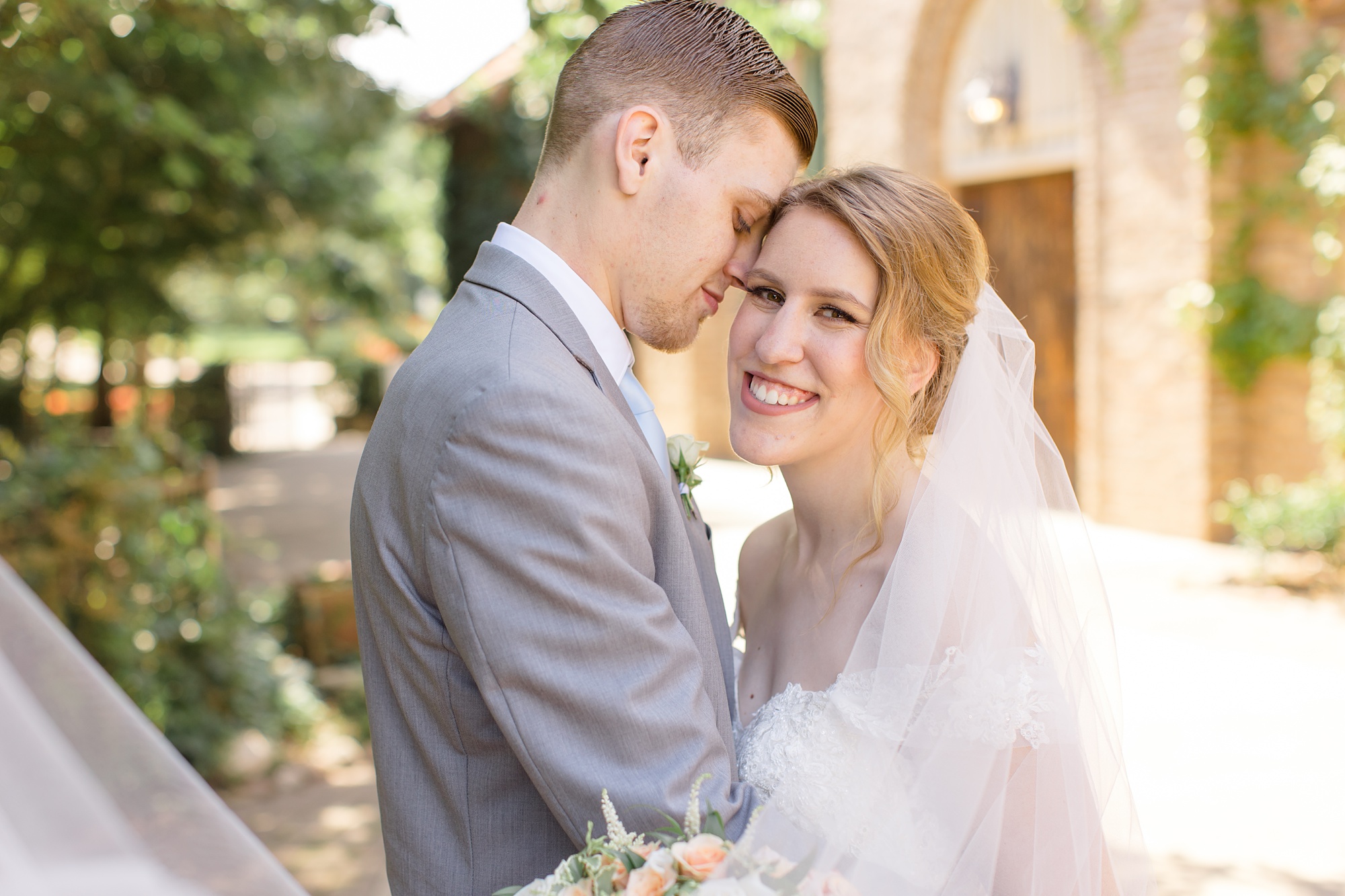 groom touches bride's forehead during Texas wedding photos