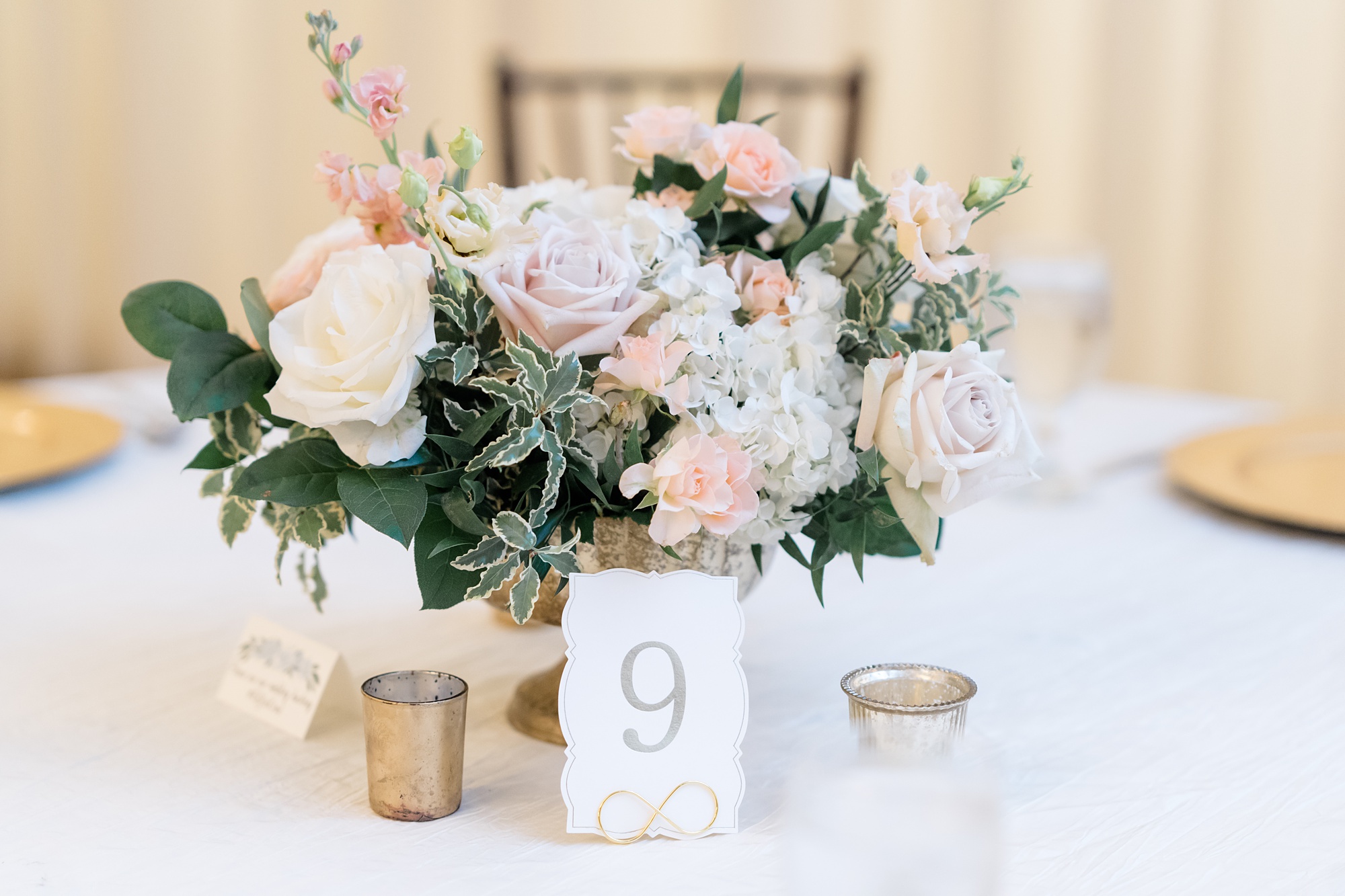 centerpieces with floral arrangement and gold candles 