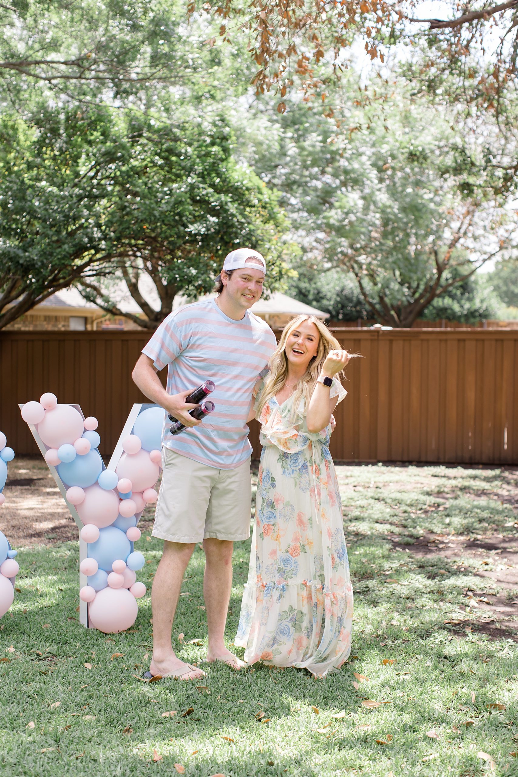 parents laugh after gender reveal for baby girl