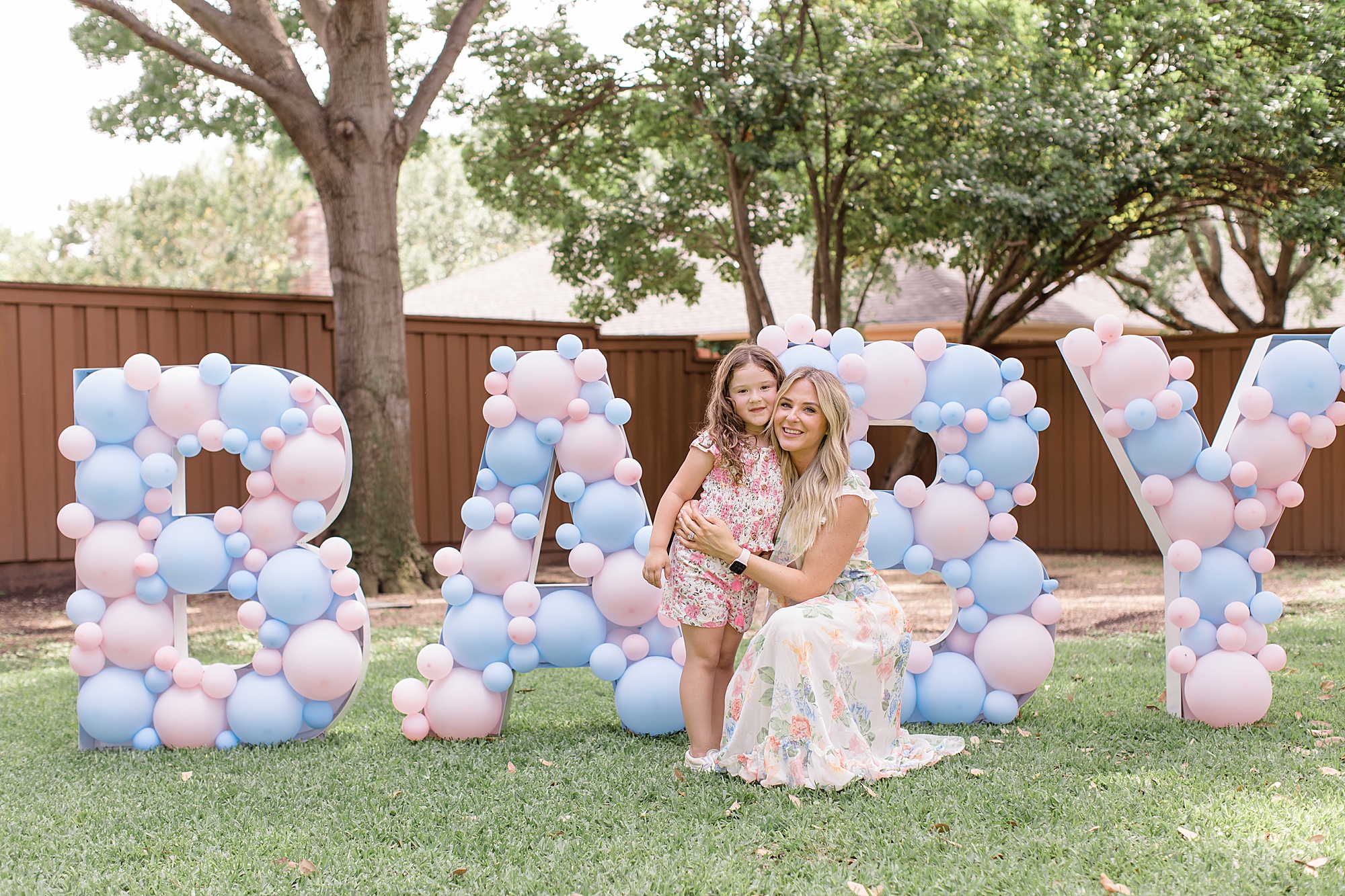 woman poses with girl during gender reveal party