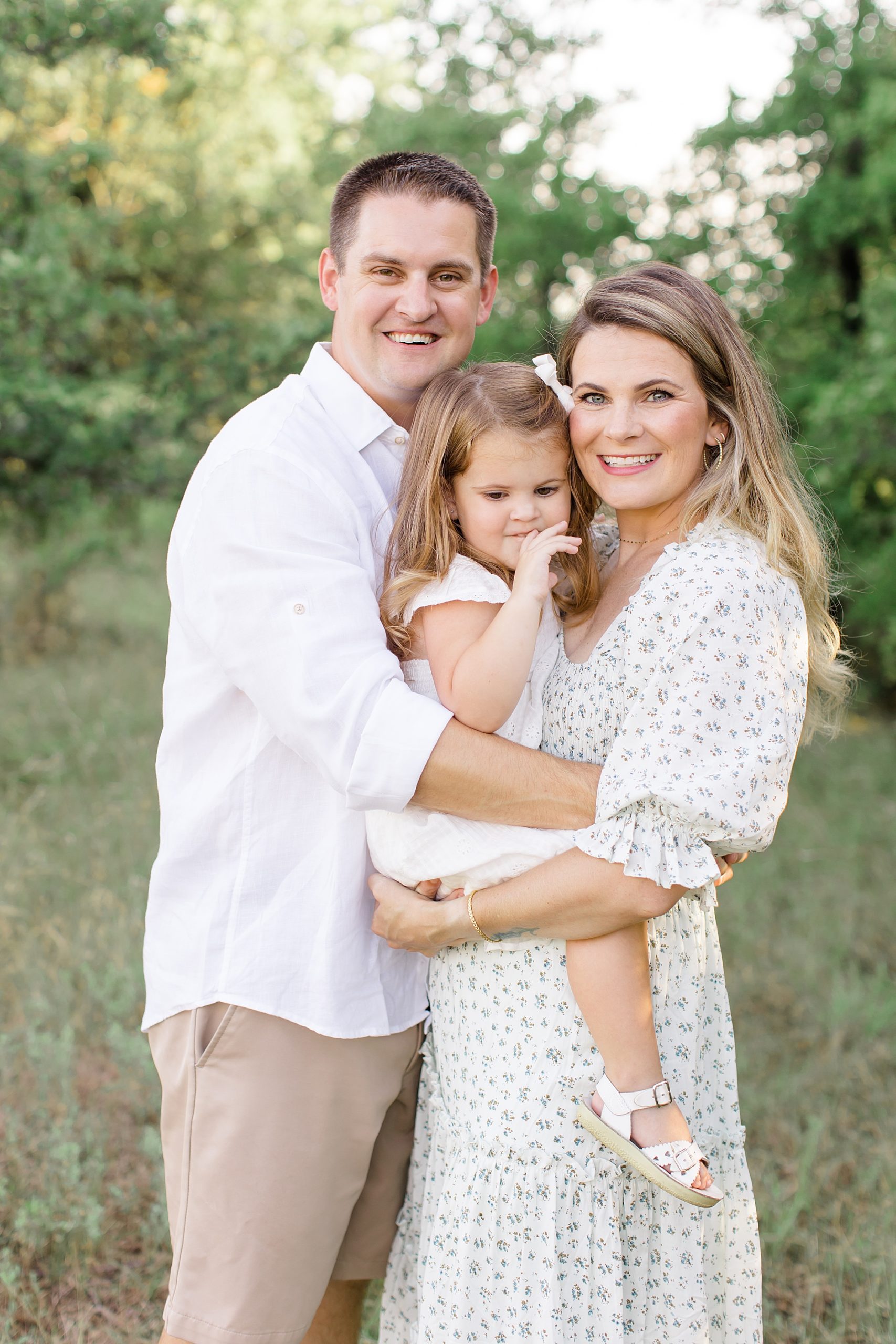 parents hold toddler during Texas family photos