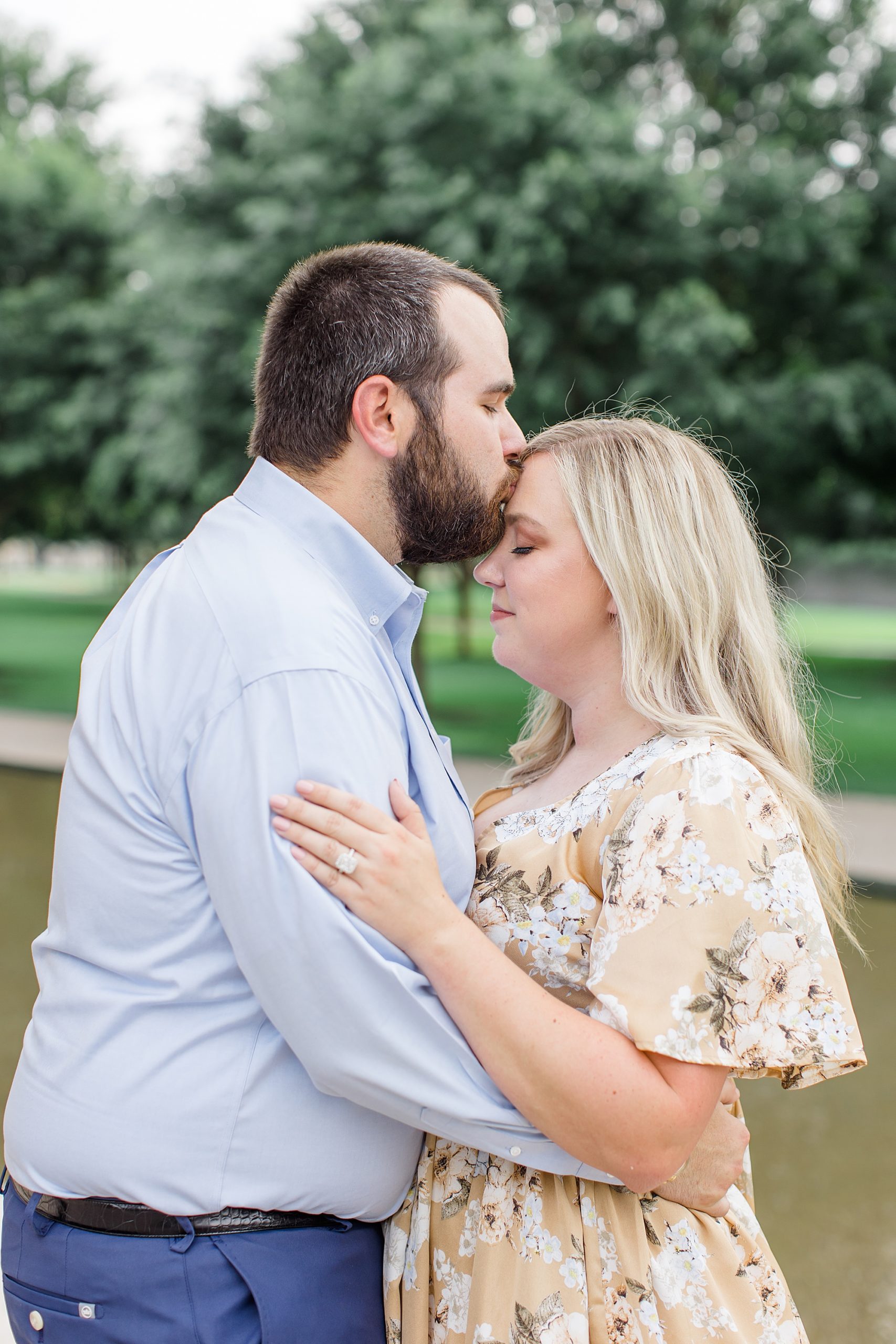groom kisses bride's forehead during TX engagement photos