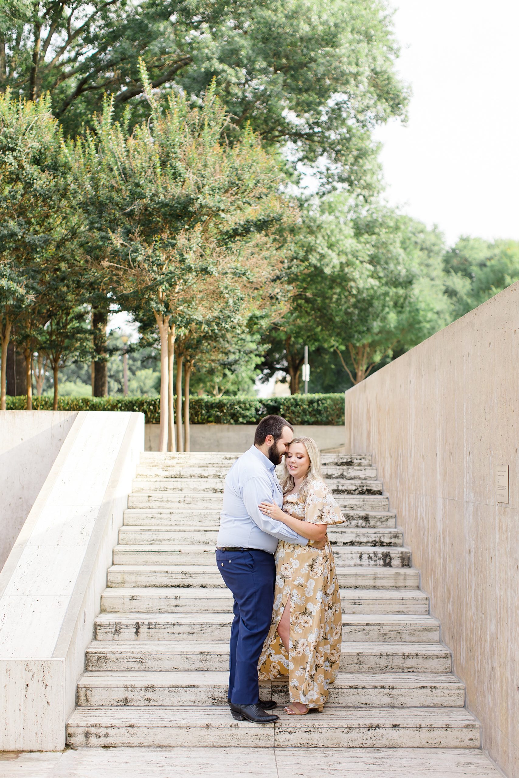 bride and groom pose on steps at Kimball Art Museum