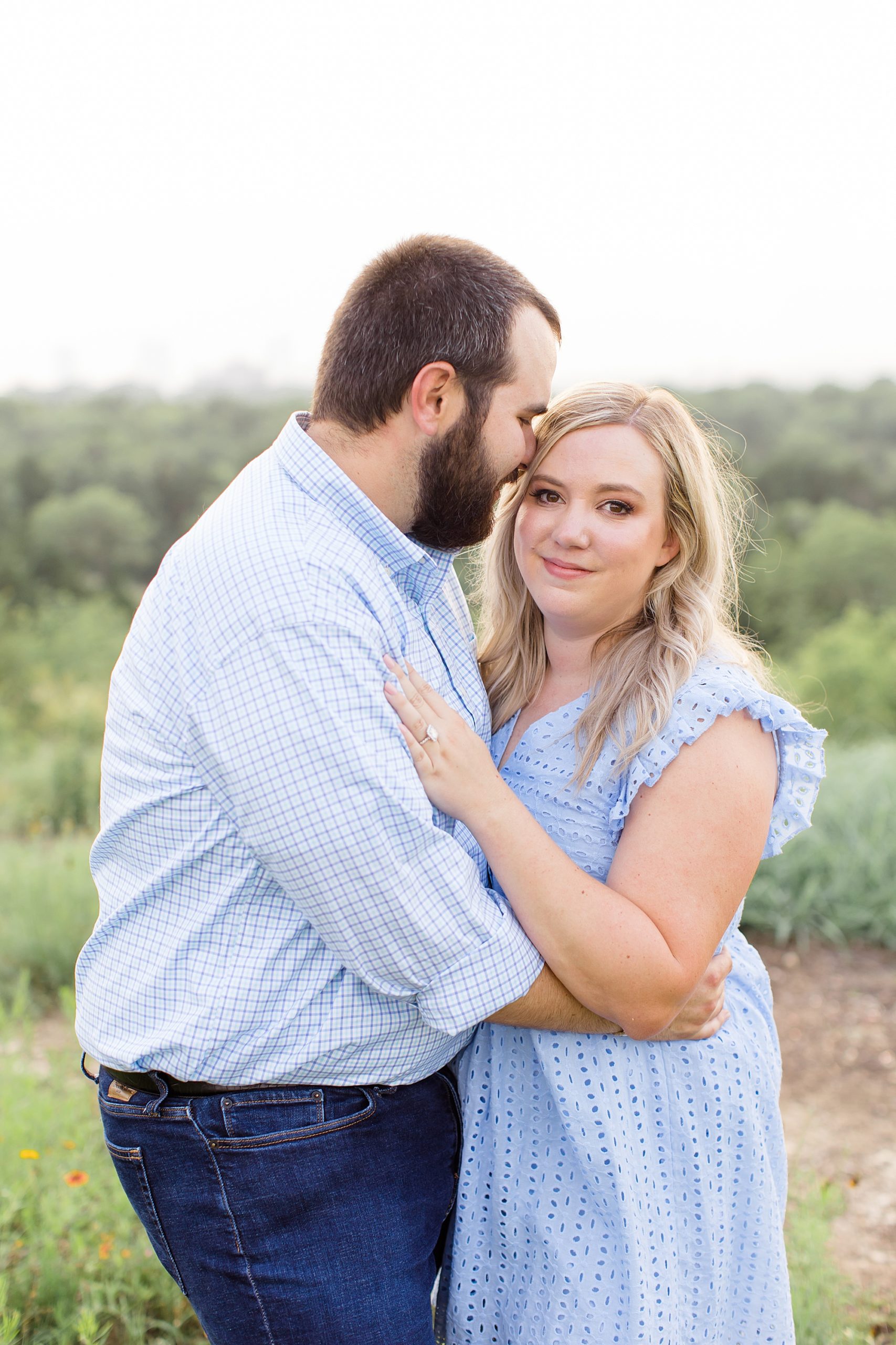 groom nuzzles bride's forehead during TX engagement photos