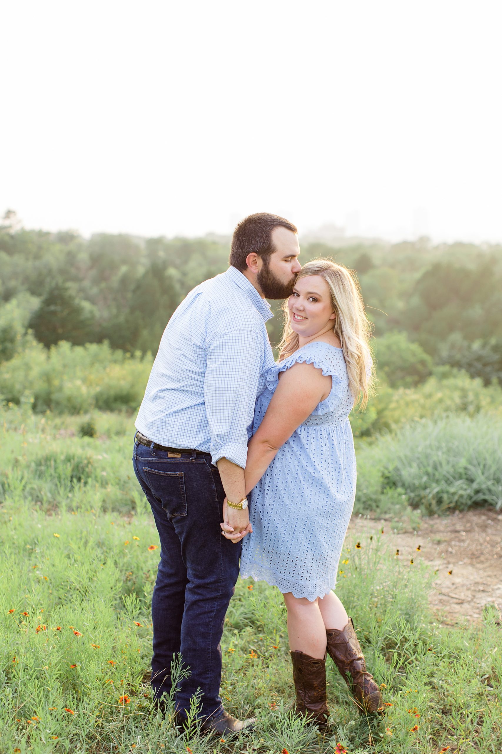 groom kisses bride's head during TX engagement photos