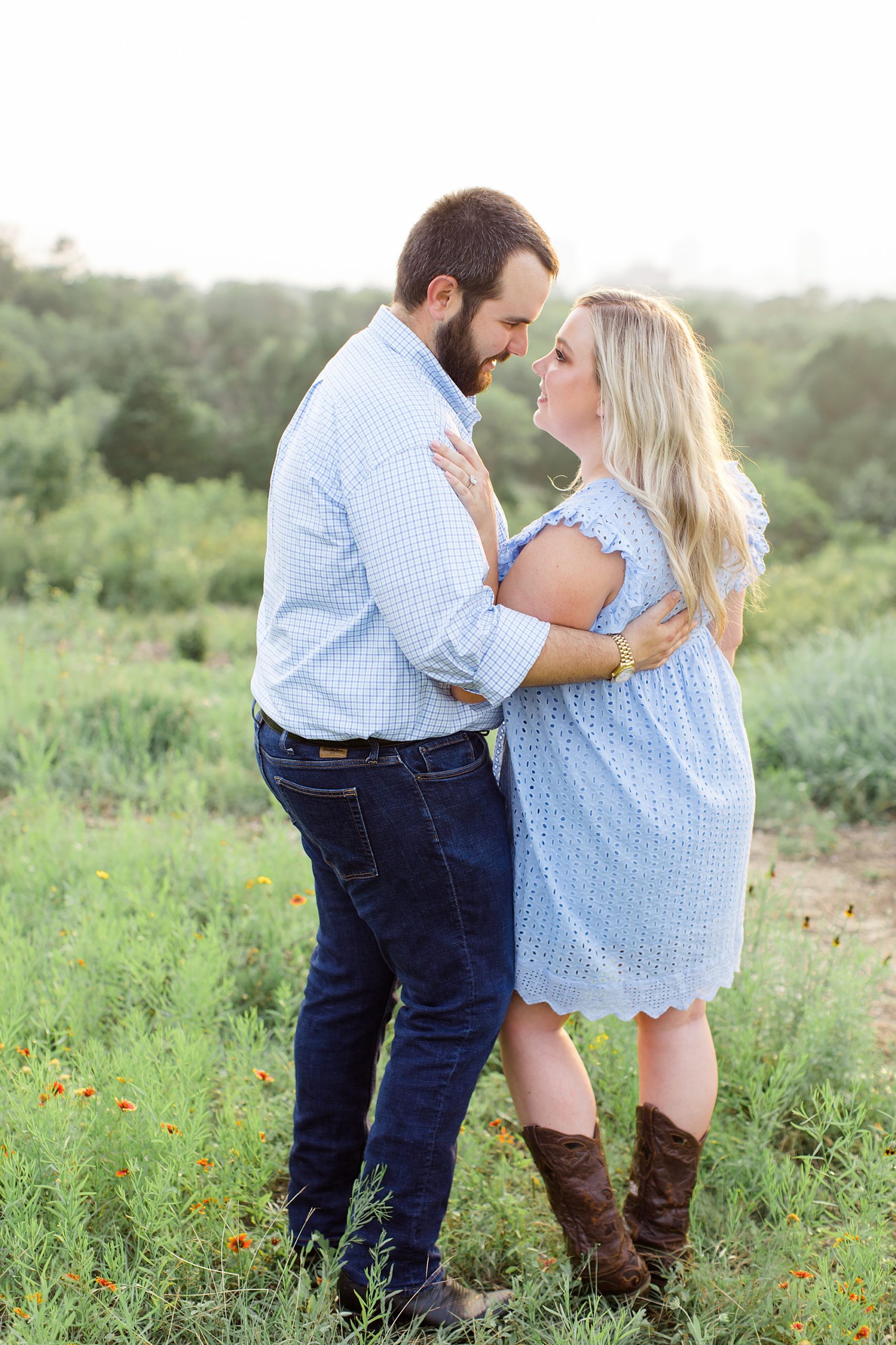 engaged couple stands on hillside at Kimball Art Museum