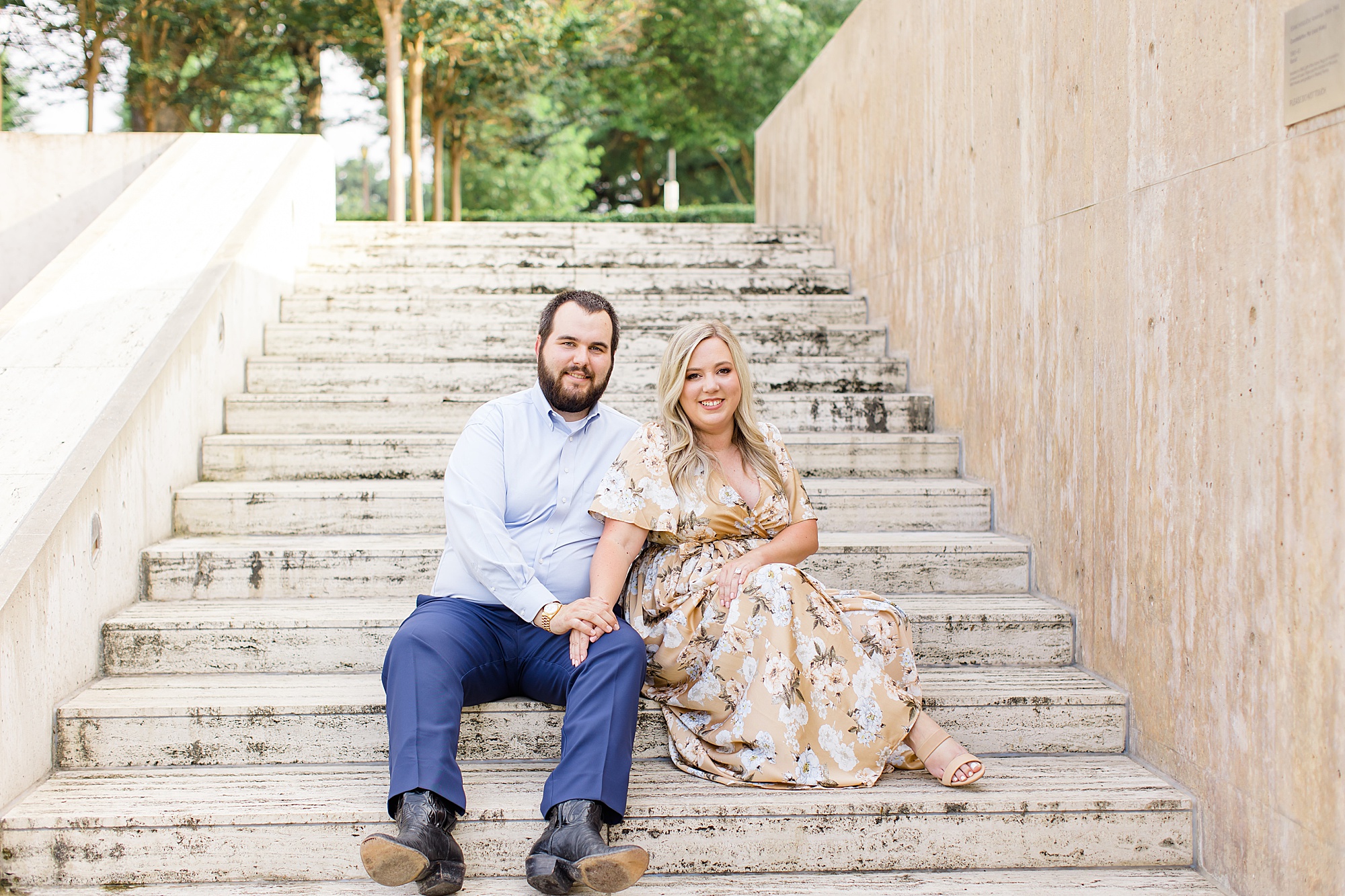 bride and groom sit on steps in Dallas TX