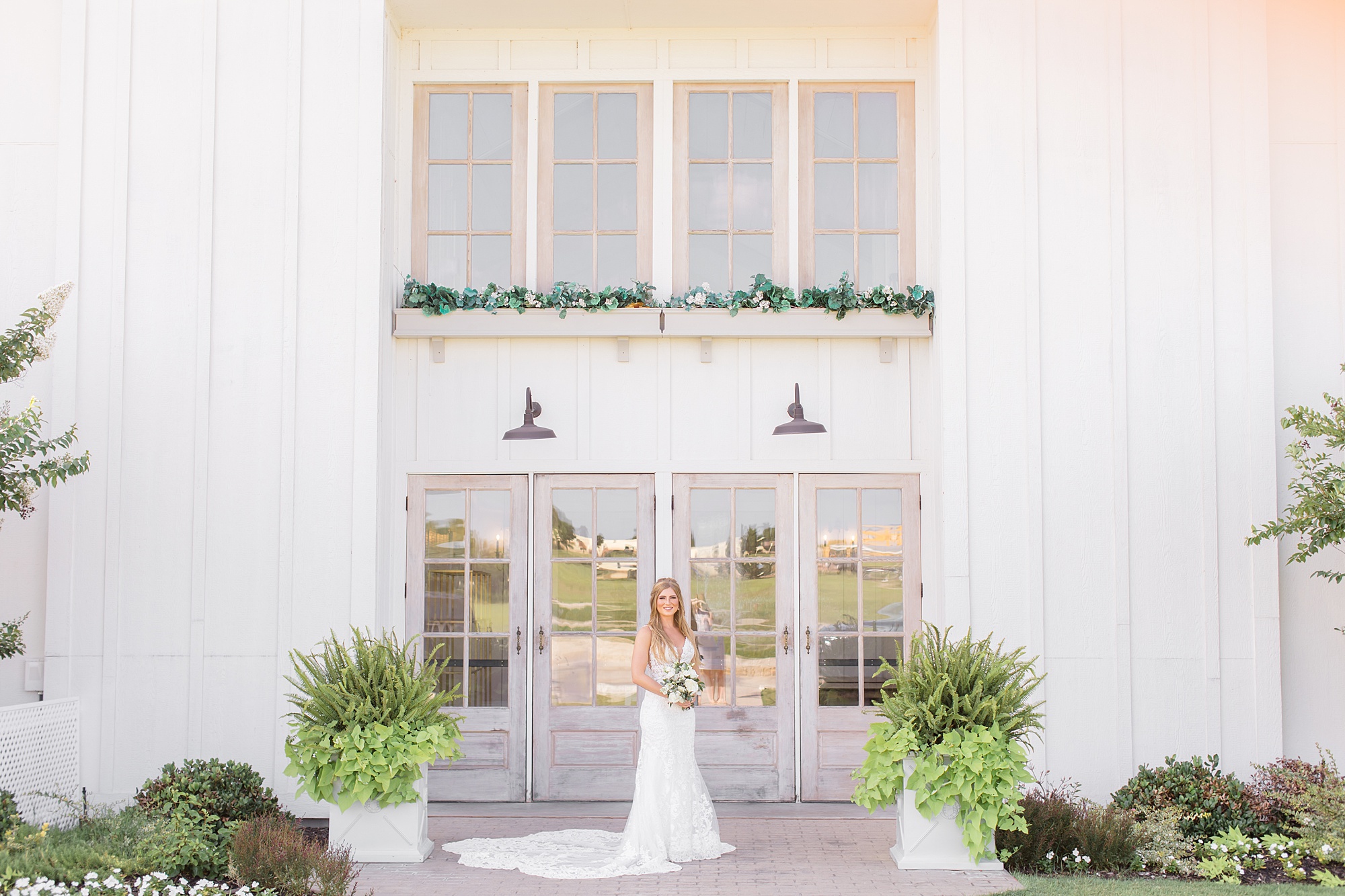 bride poses outside reception hall at The Grand Ivory