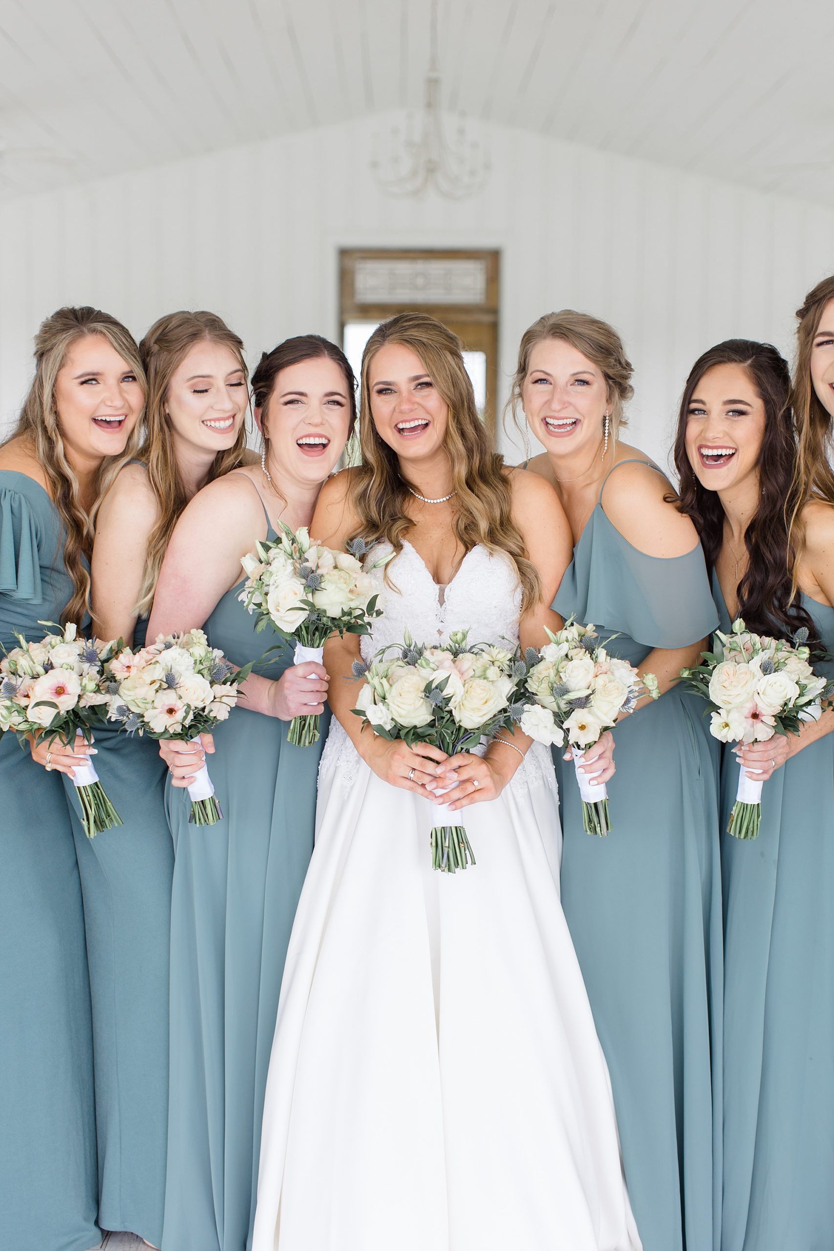 bride laughs with bridesmaids during The Grand Ivory wedding photos